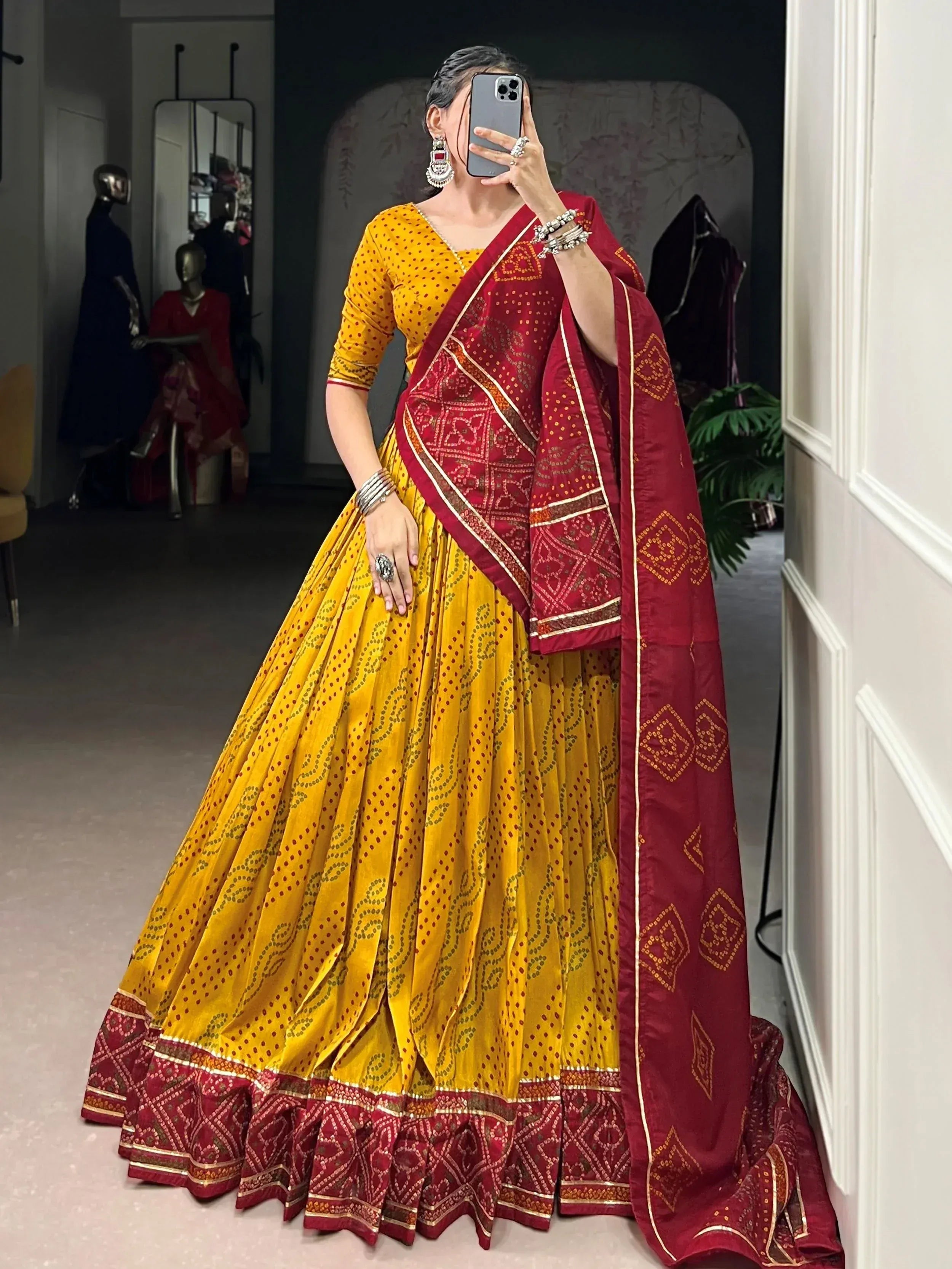 Yellow and maroon ethnic lehenga choli with printed patterns and dupatta, perfect for festive occasions