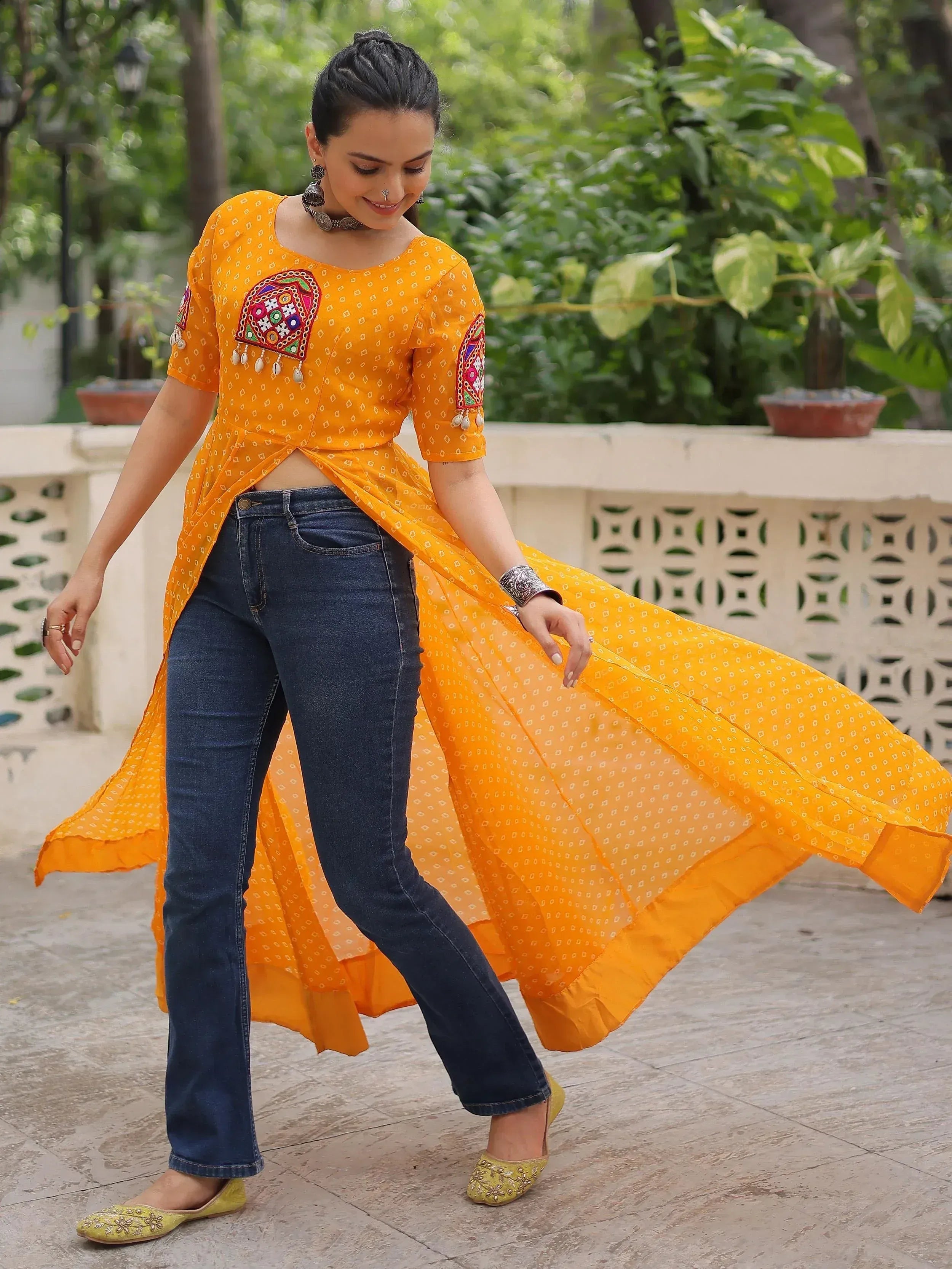 Yellow embroidered ethnic kurta with denim jeans, perfect for fusion Indian wear