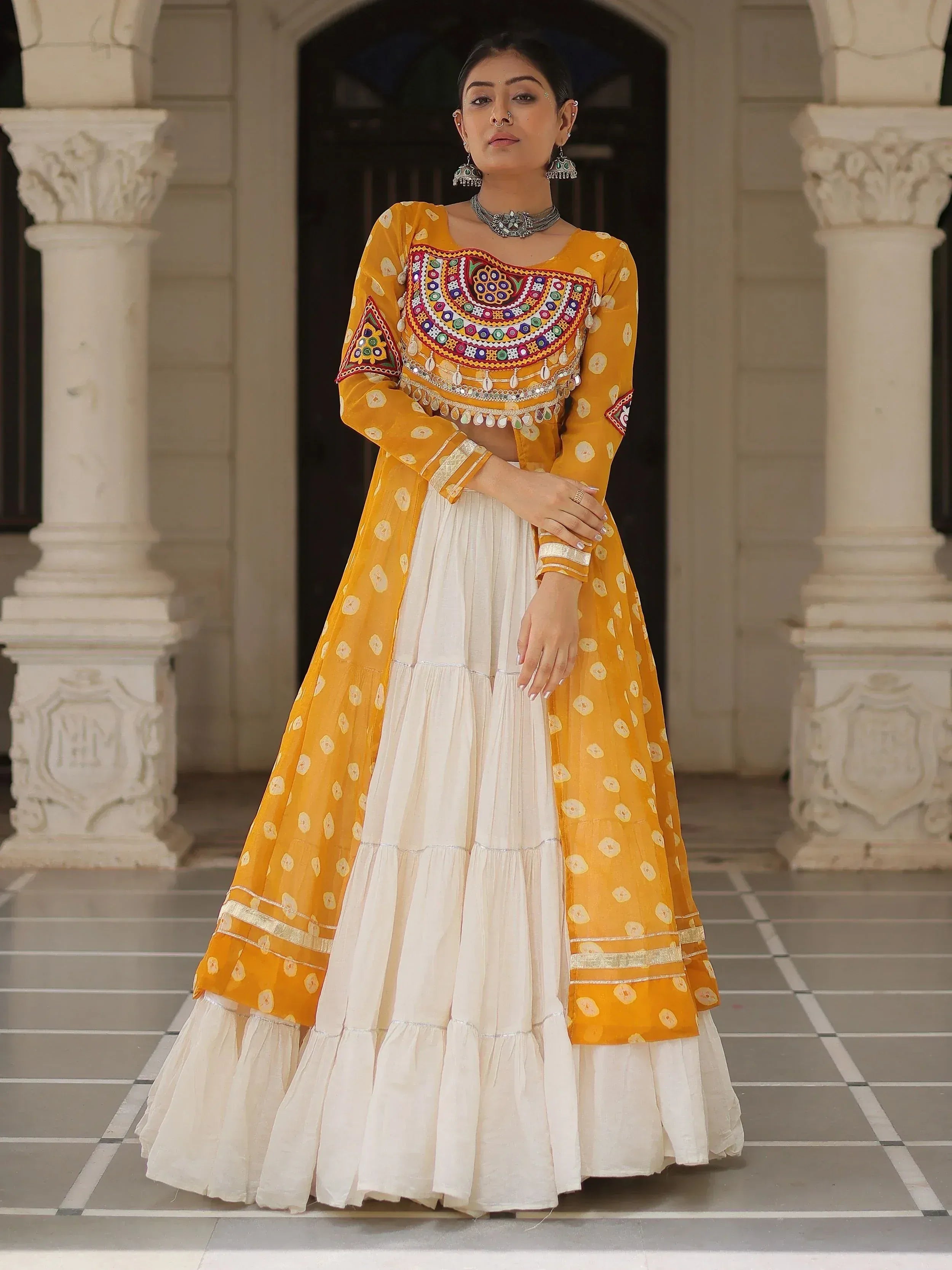 Yellow and white embroidered Indian ethnic wear with mirror work, perfect for festive occasions