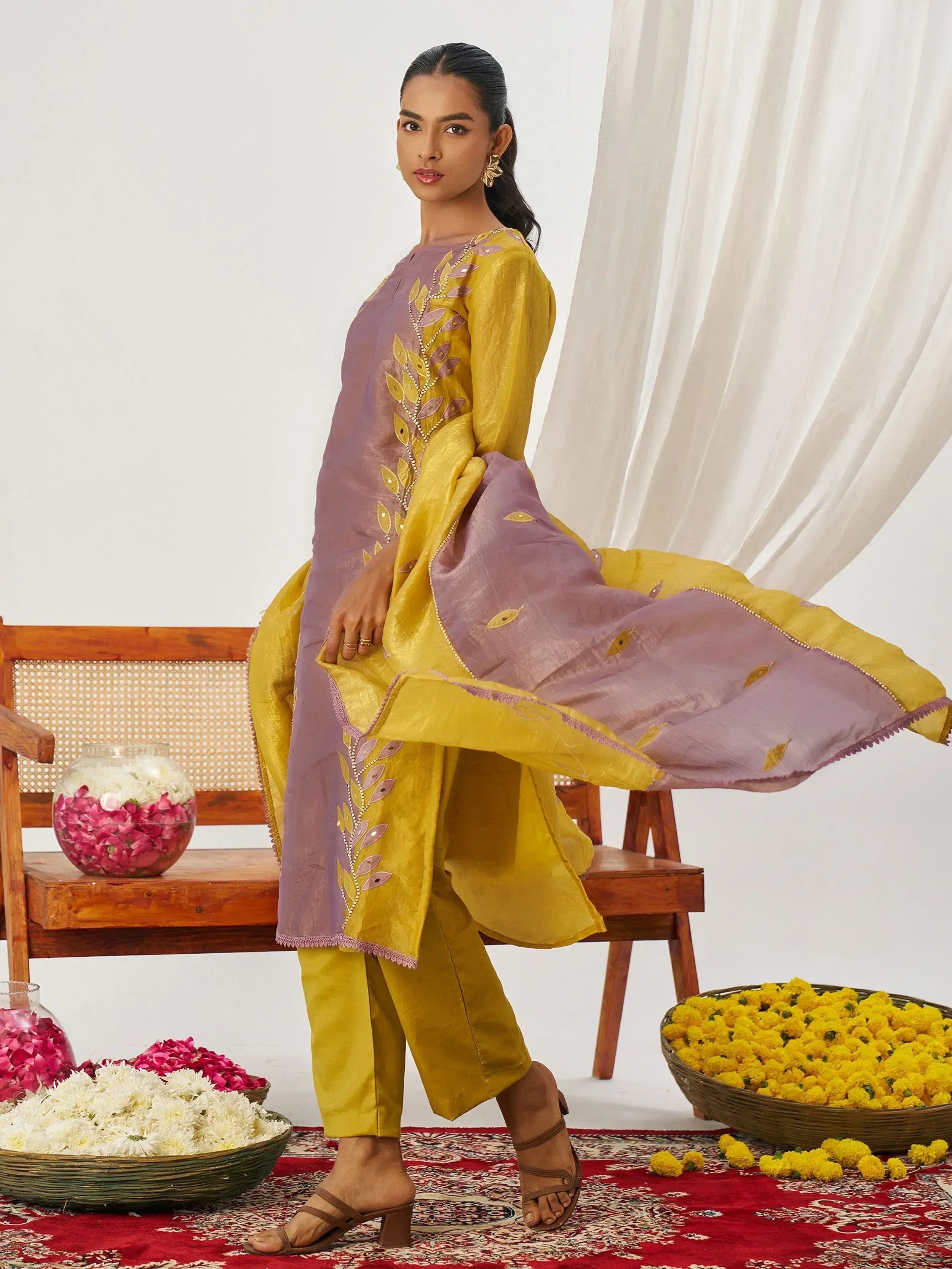 Yellow and purple embroidered salwar kameez with floral motifs, perfect for Indian ethnic wear occasions