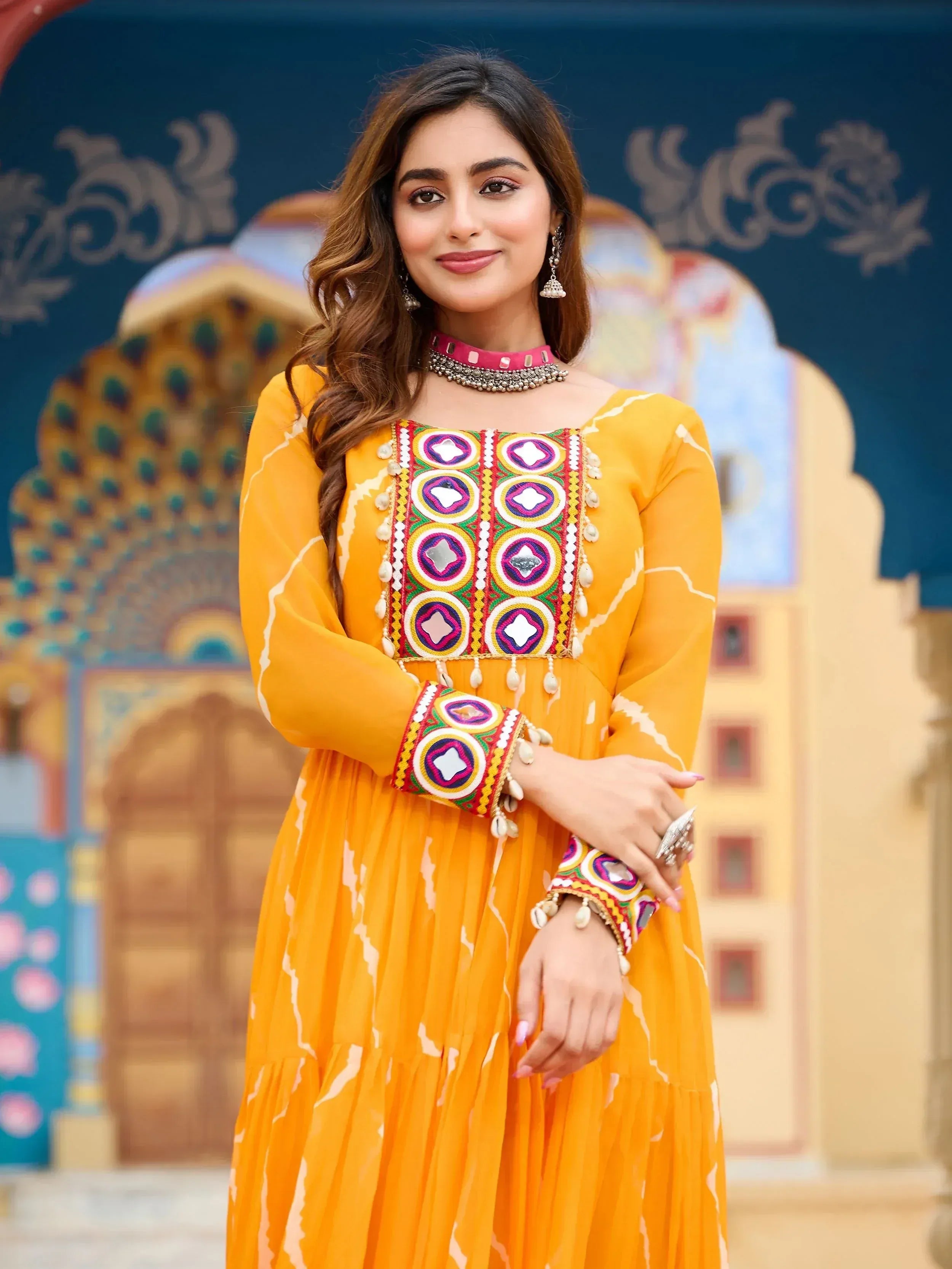 Yellow ethnic gown with mirror work and embroidery, perfect for Indian festive occasions