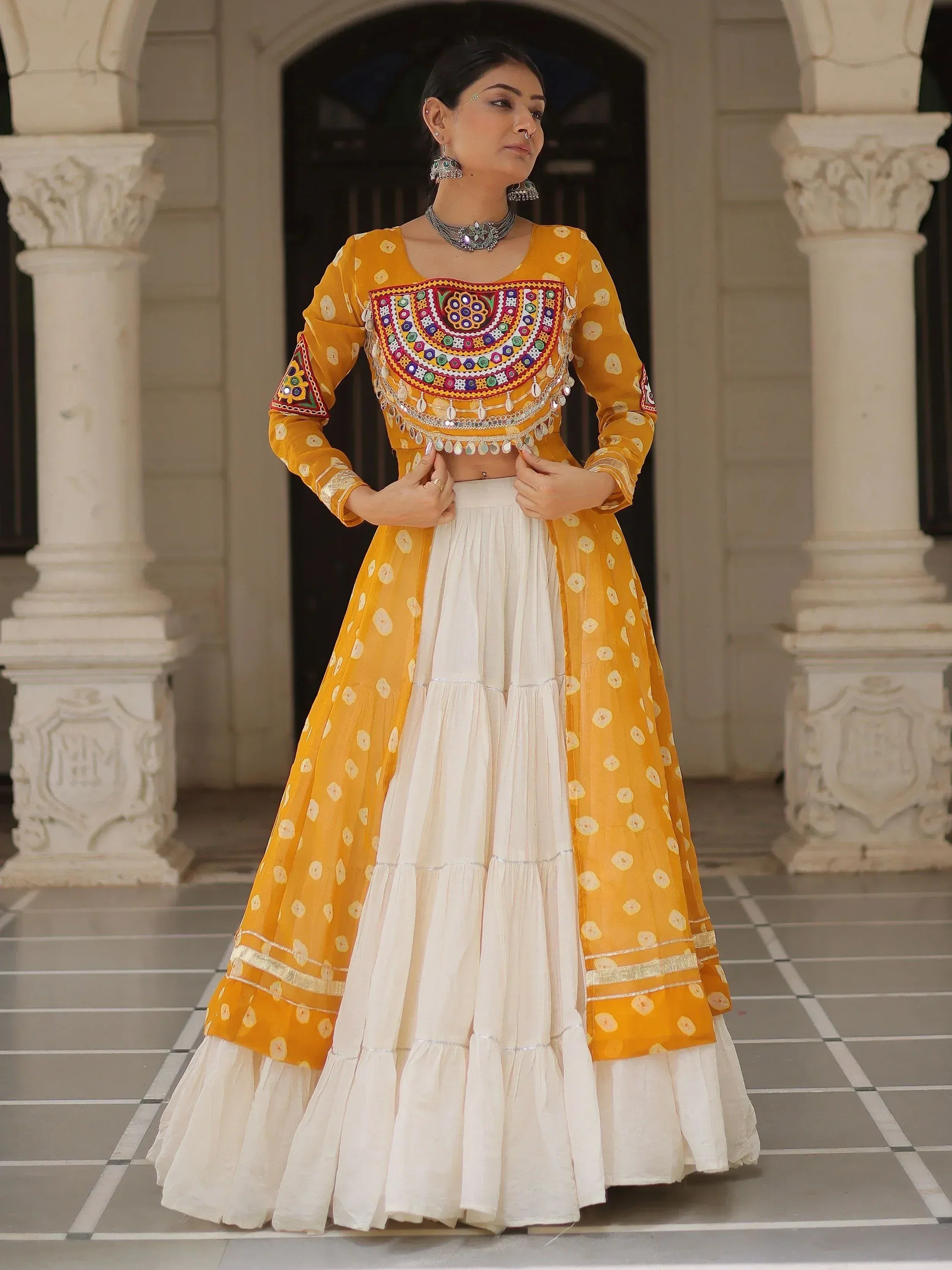 Yellow and white embroidered lehenga choli with mirror work, perfect for Indian ethnic wear occasions