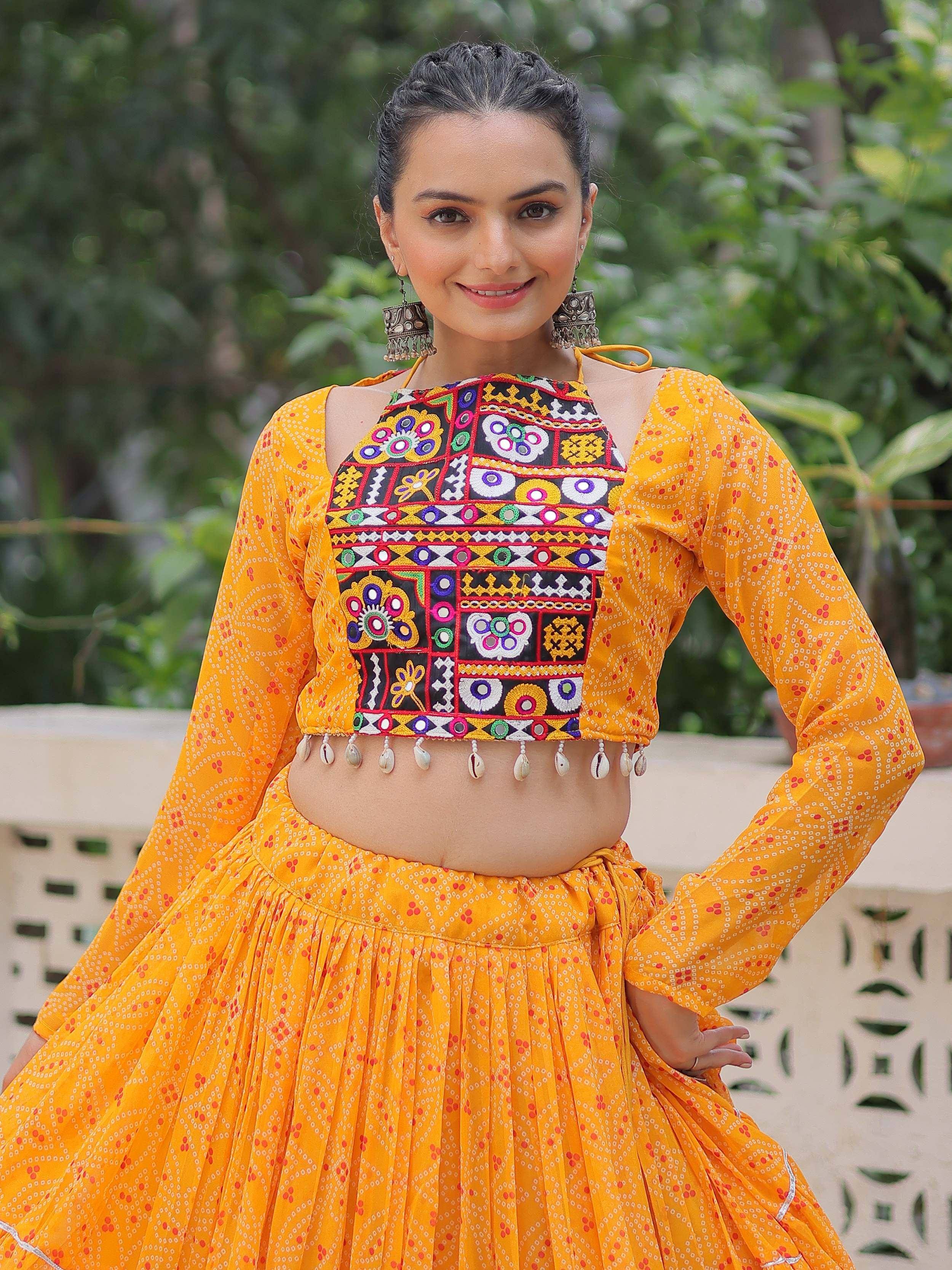 Vibrant yellow ethnic lehenga choli with colorful embroidery and shell detailing, perfect for festive occasions.