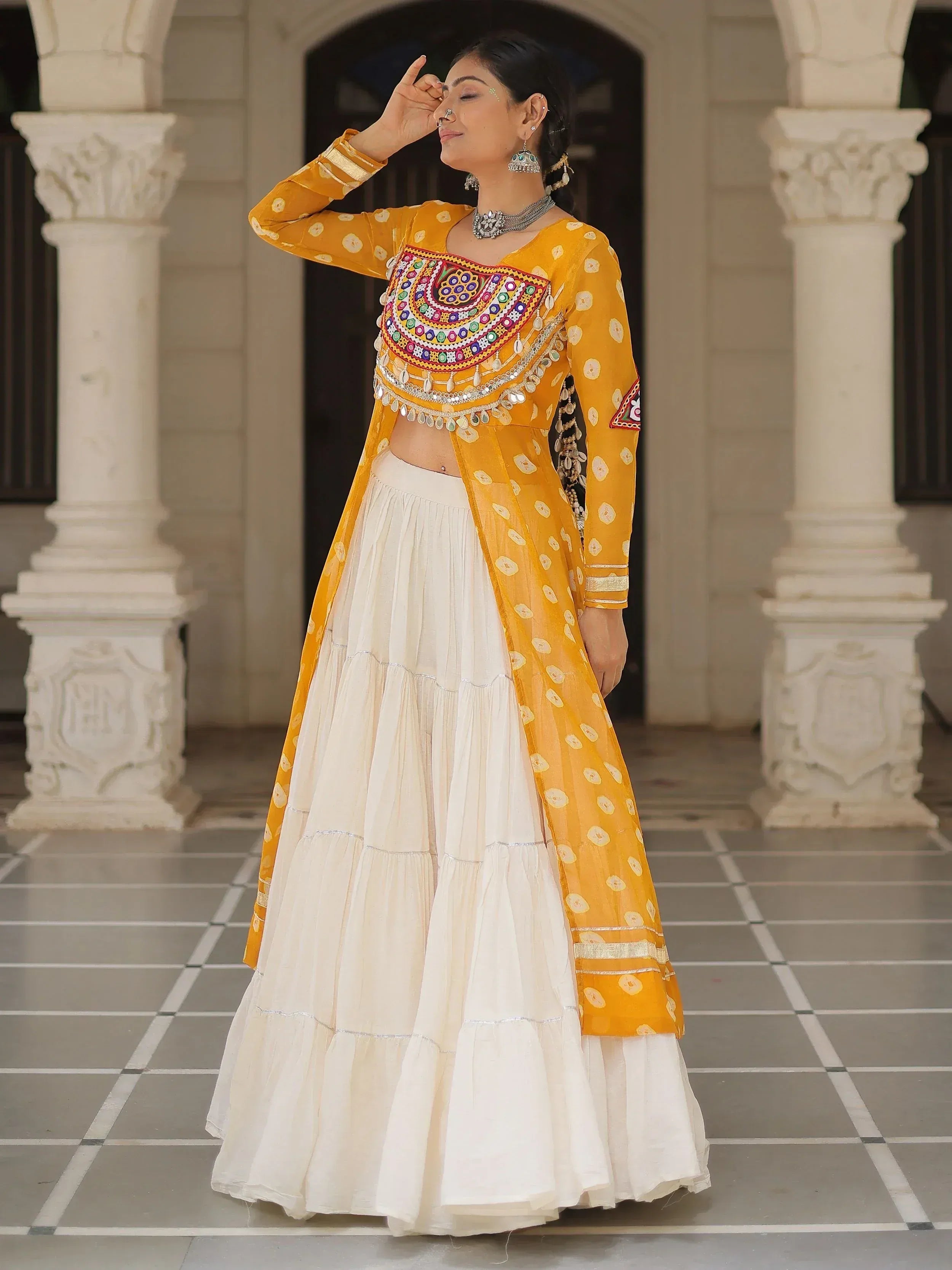 Yellow embroidered choli with white tiered lehenga, traditional Indian ethnic wear for women
