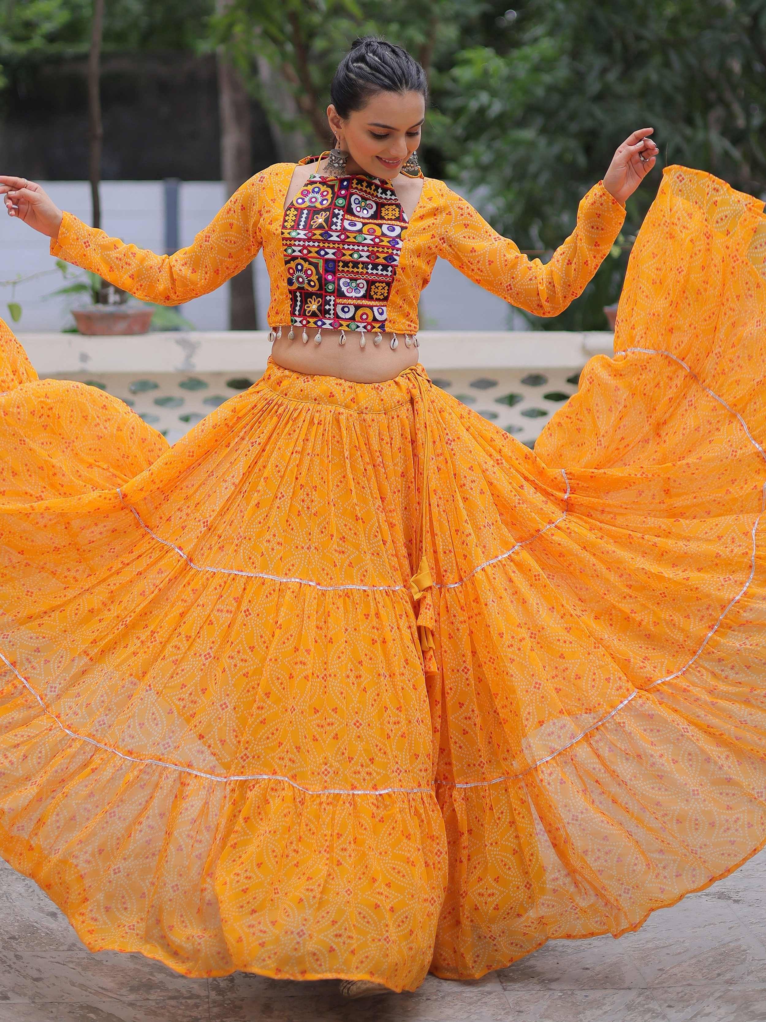 Vibrant yellow ethnic lehenga choli with embroidered crop top and flared skirt, perfect for festive occasions.