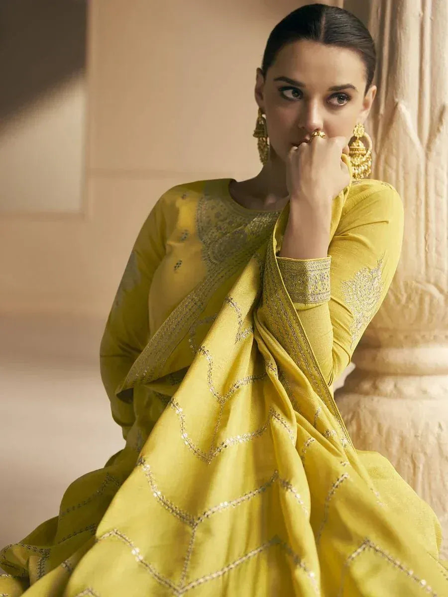 Yellow embroidered salwar kameez with gold detailing, styled with traditional Indian jewelry