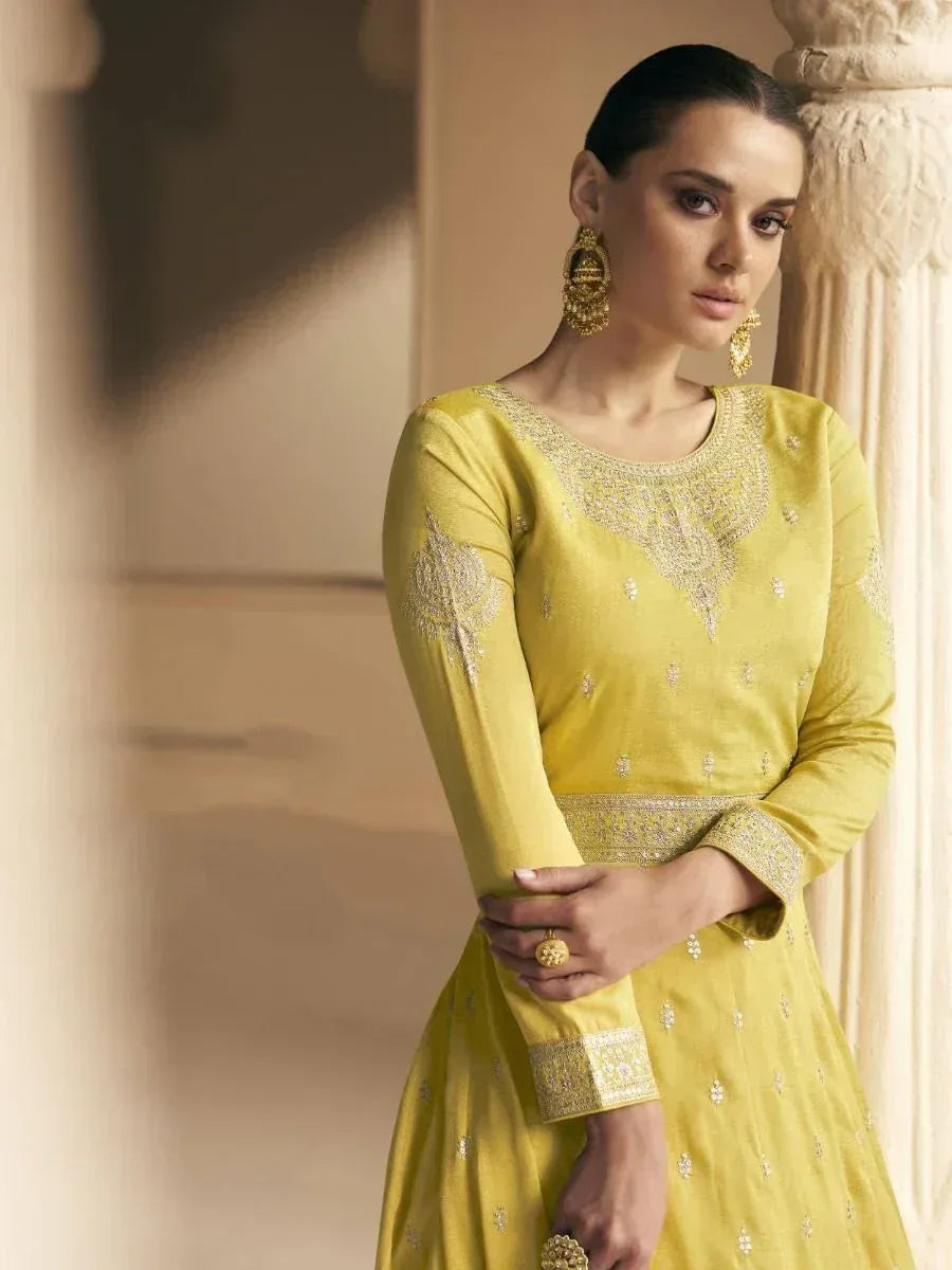 Yellow embroidered ethnic gown with gold detailing, perfect for Indian festive occasions