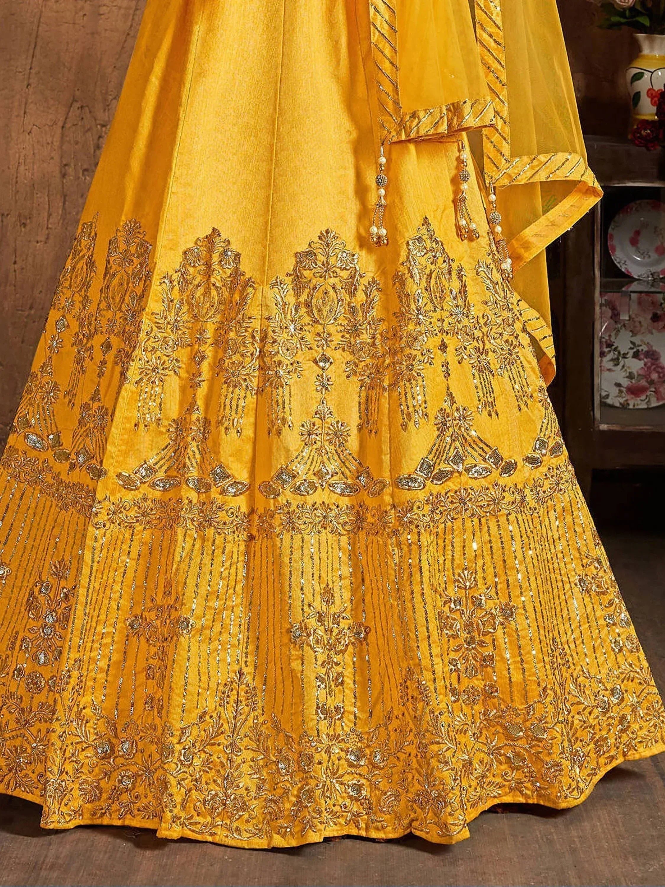 Yellow designer lehenga choli with heavy gold embroidery and sequin work for Indian ethnic wear