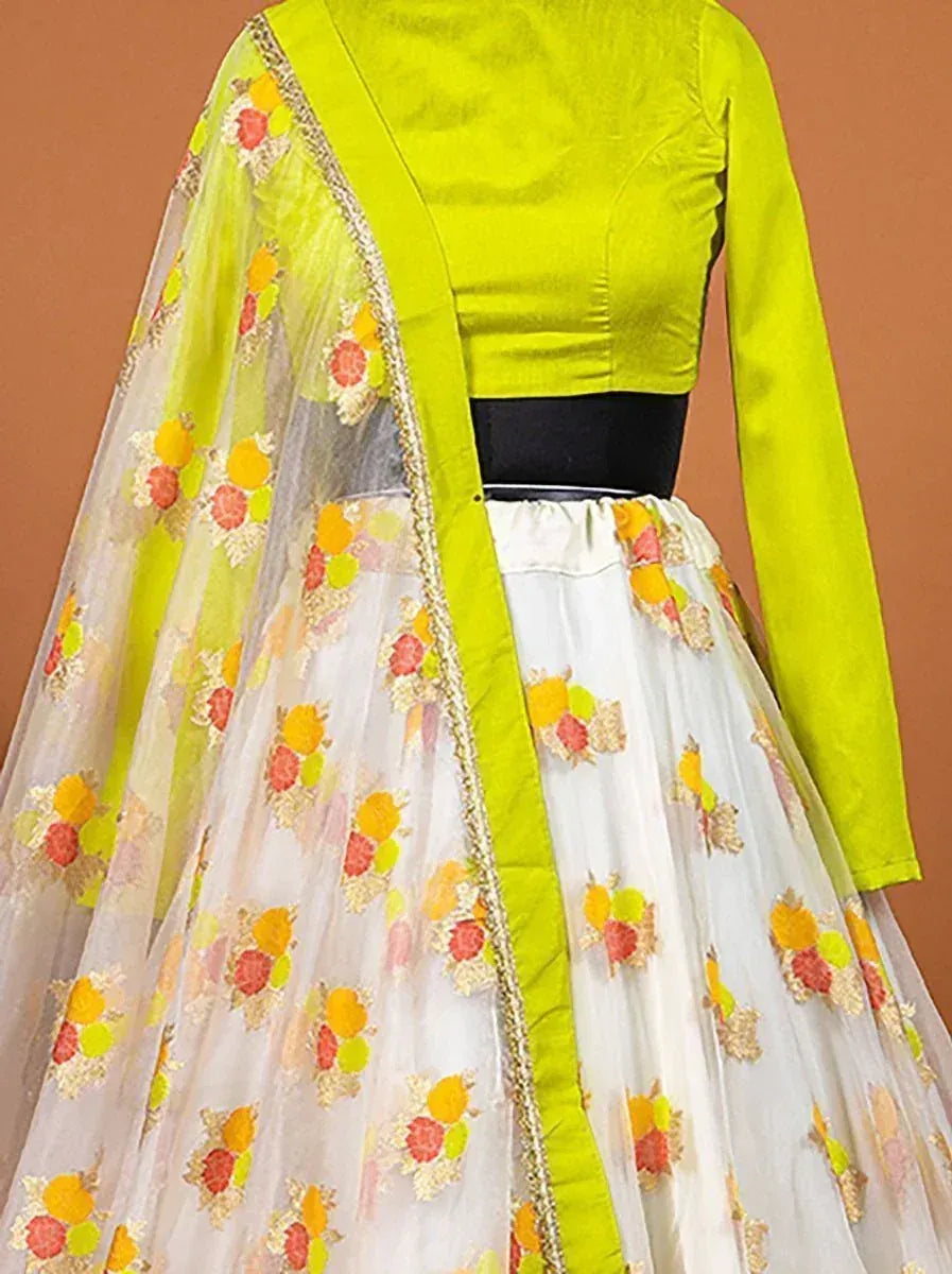 Lime green designer lehenga choli with floral embroidery and sheer dupatta, perfect for ethnic occasions.