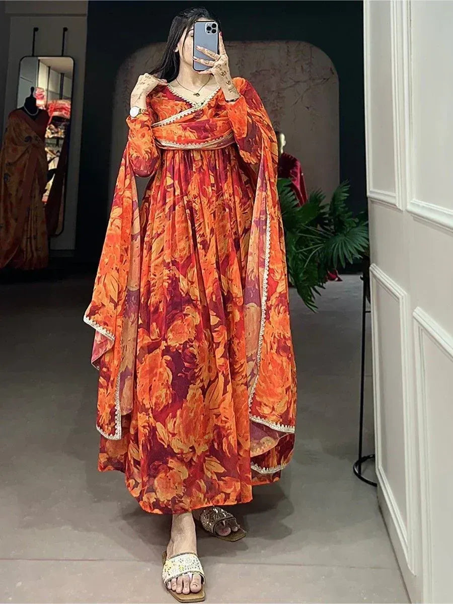 Vibrant orange floral ethnic gown with cape sleeves, perfect for Indian festive occasions