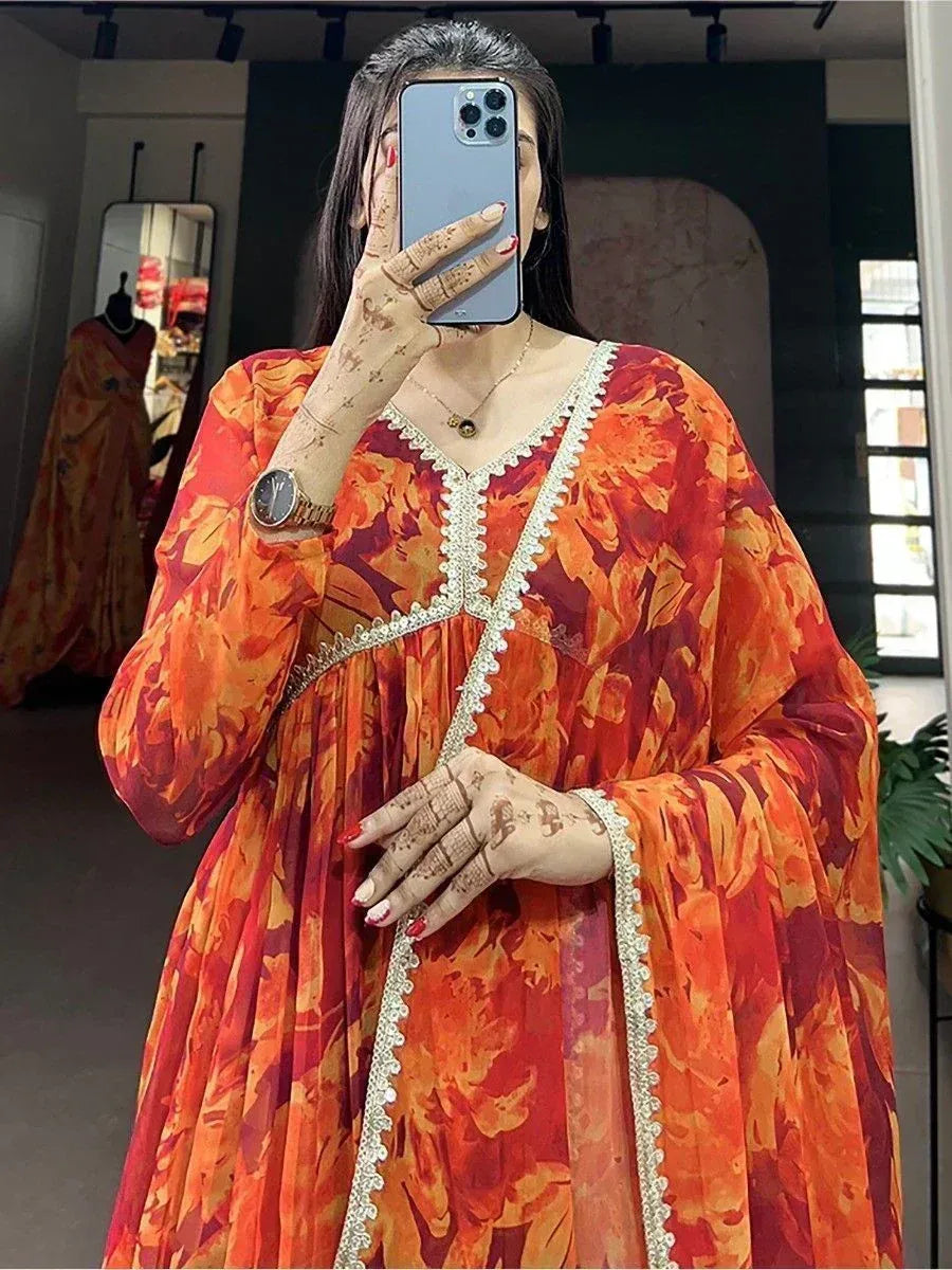Vibrant orange floral ethnic gown with white lace trim, perfect for Indian occasions