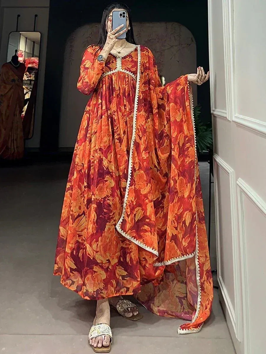 Orange floral print ethnic gown with white trim, perfect for Indian occasions and festive wear.