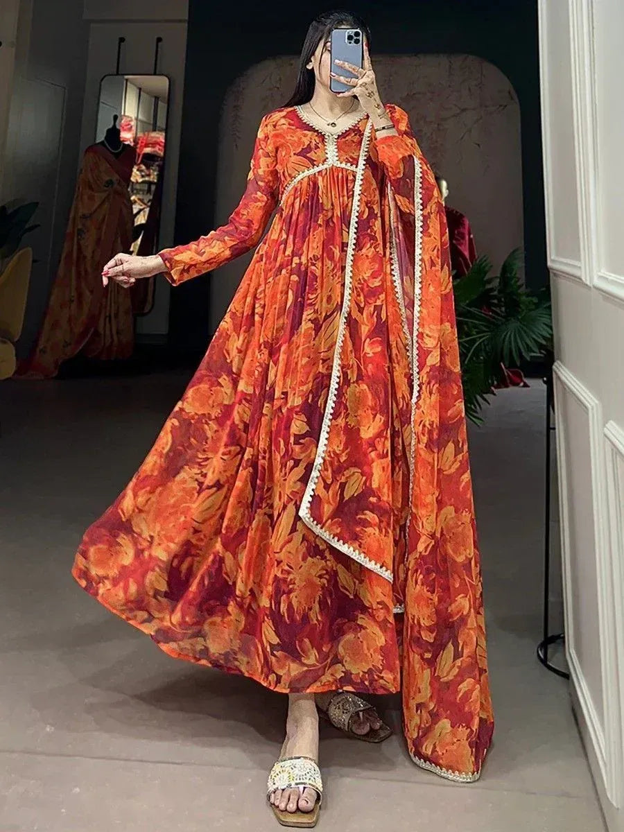 Orange floral print ethnic gown with white trim, perfect for festive occasions and Indian wear.