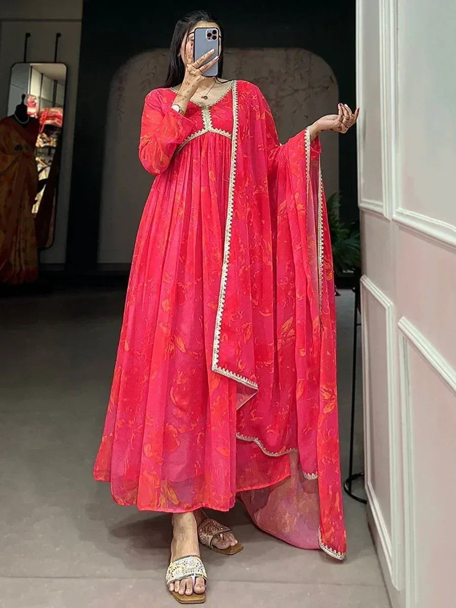 Vibrant pink floral ethnic gown with gold trim, perfect for Indian occasions and festive wear.
