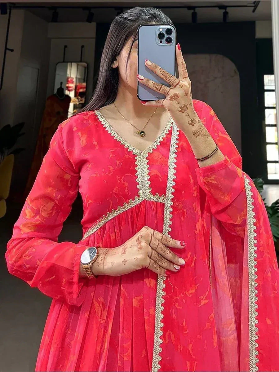 Woman in red floral ethnic gown with gold embroidery, henna hands, mirror selfie