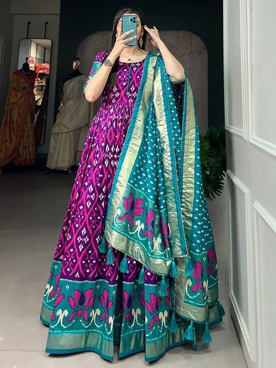 Vibrant purple and teal ikat print anarkali gown with matching dupatta, perfect for Indian ethnic occasions.