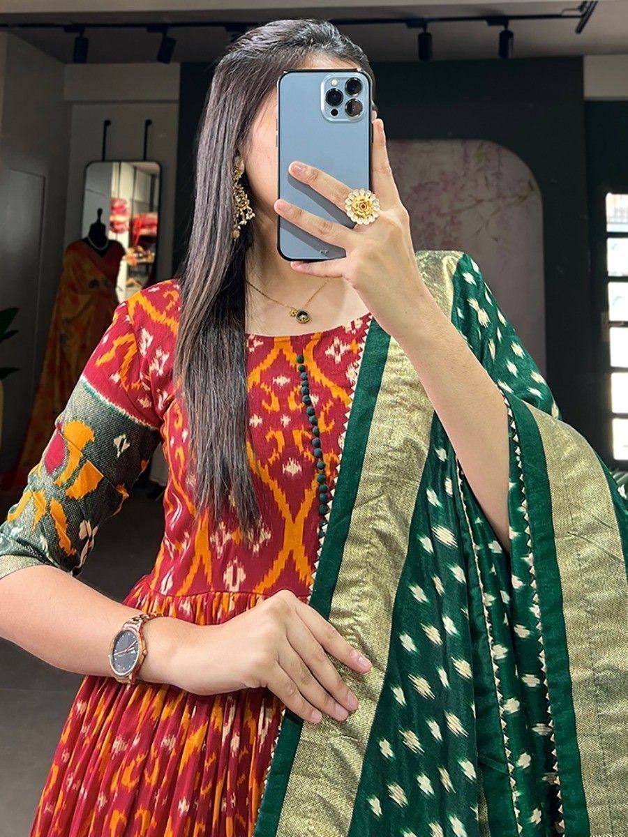 Woman in red and green ikat print ethnic gown with matching dupatta, perfect for Indian occasions
