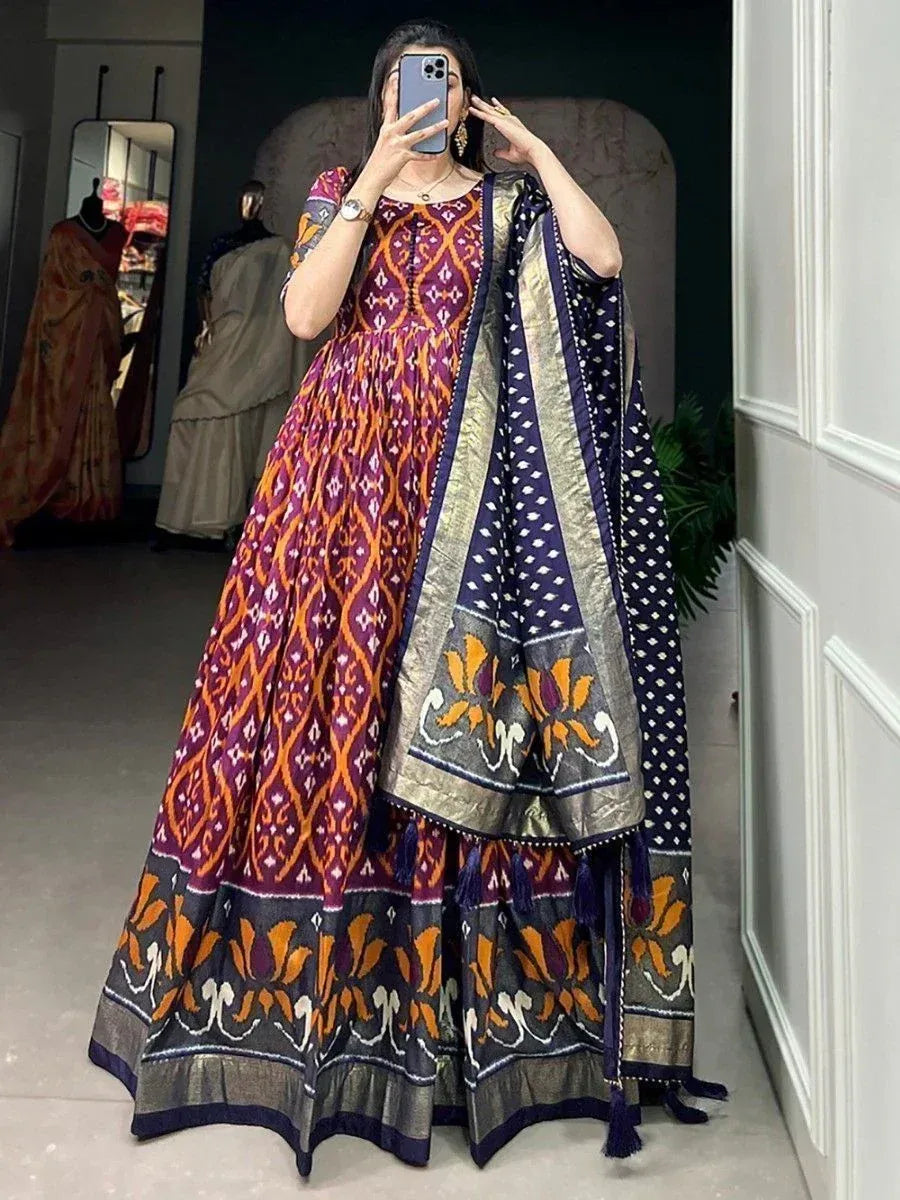 Woman in vibrant purple and orange ikat print anarkali with matching dupatta, ethnic Indian wear