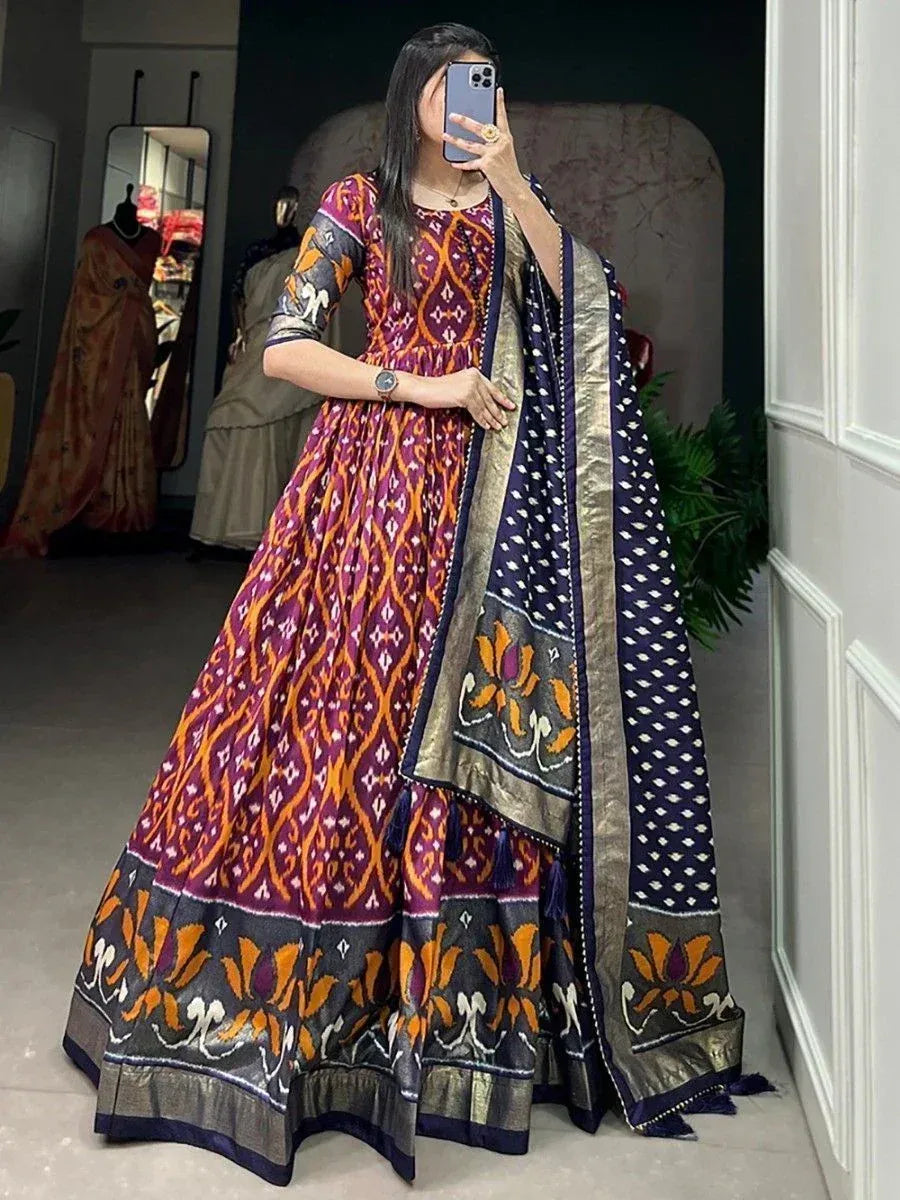 Woman in vibrant purple and orange ikat print anarkali with matching dupatta, ethnic Indian wear