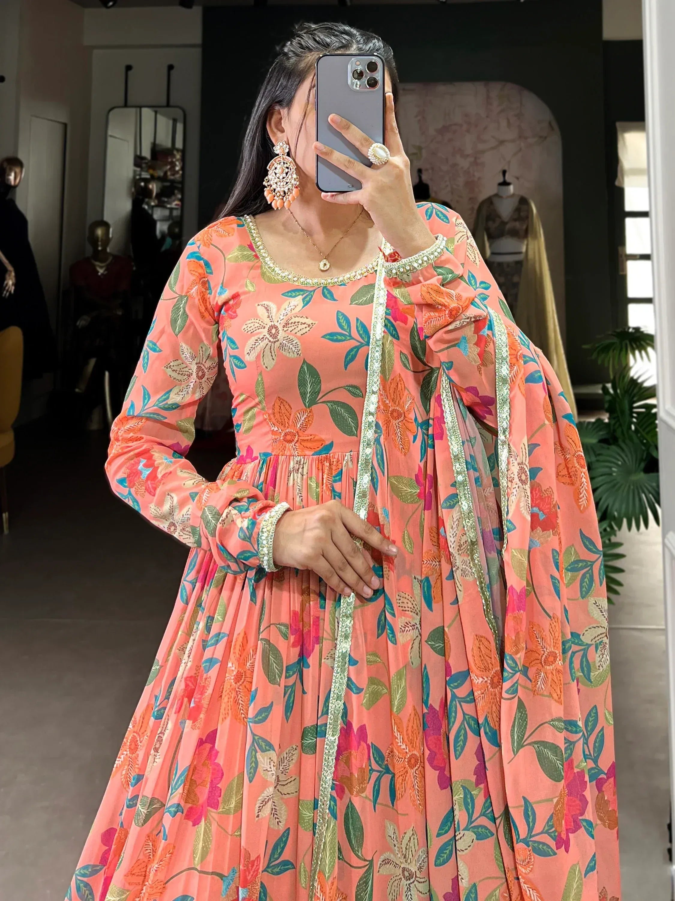 Peach floral printed ethnic gown with gold trim, perfect for Indian occasions and festive wear.