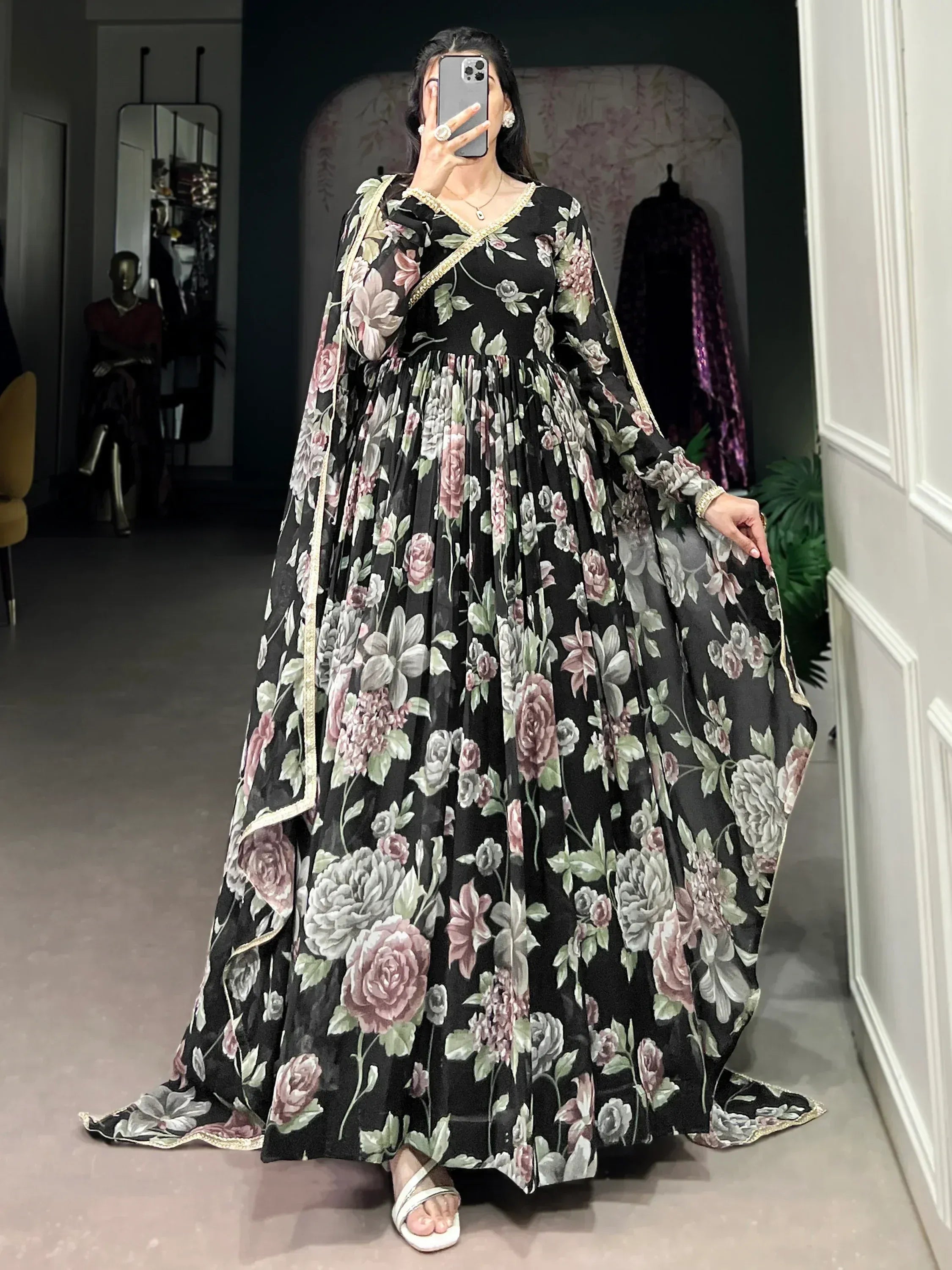Black floral print ethnic gown with gold trim, perfect for Indian occasions and parties.