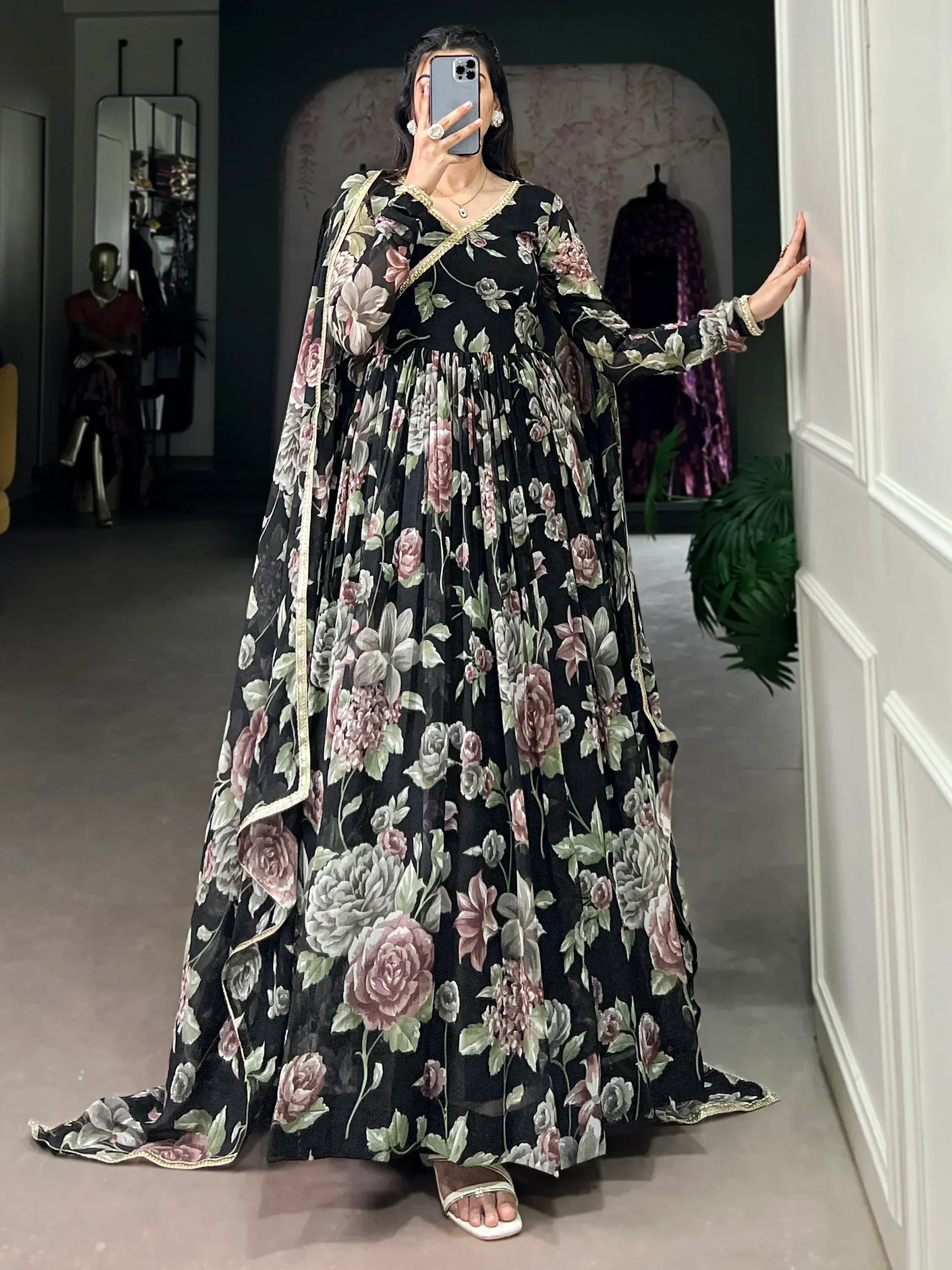Black floral printed ethnic gown with gold trim, perfect for Indian occasions and festive wear.