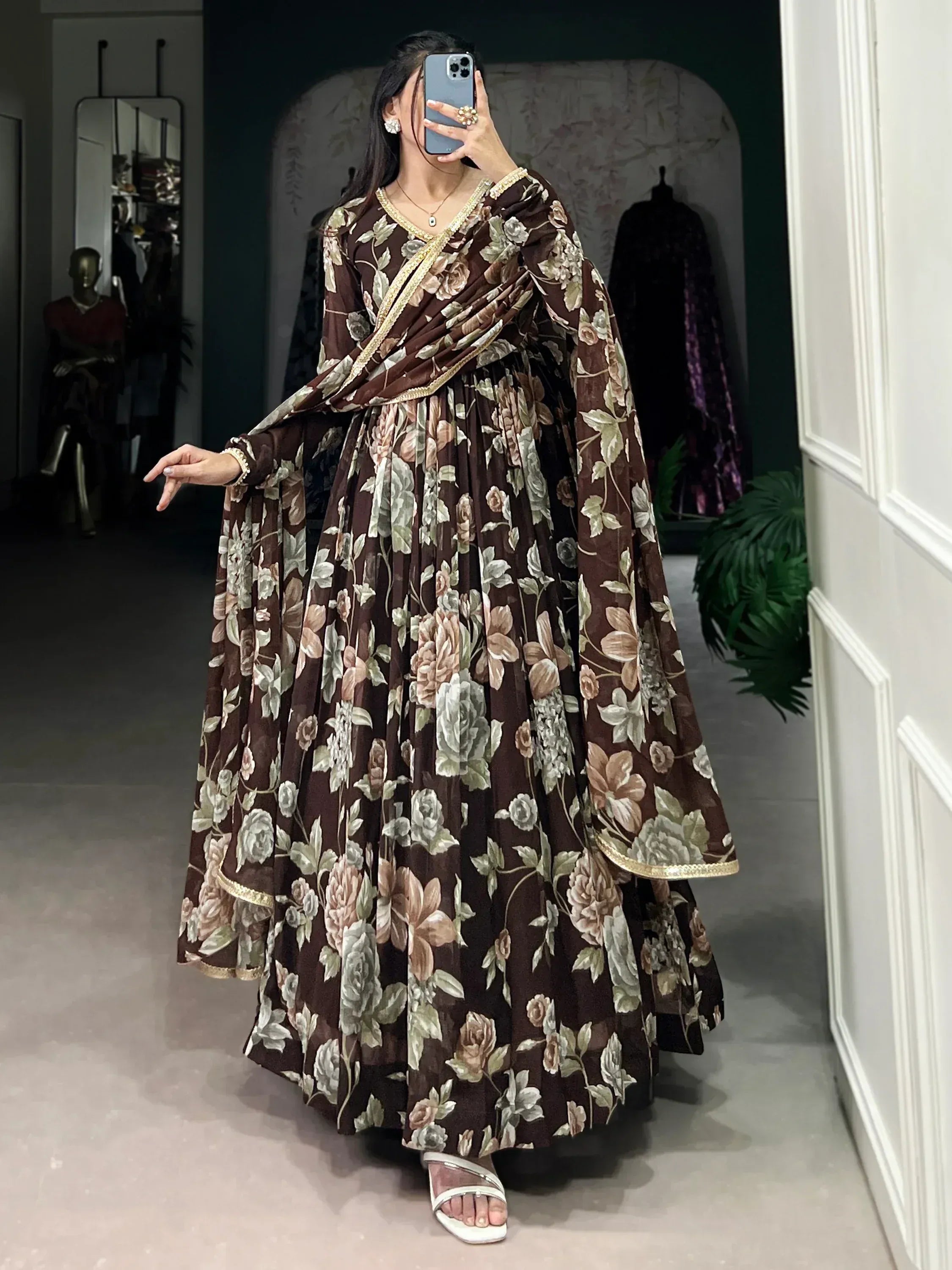 Brown floral print Indian ethnic gown with gold trim, perfect for festive occasions and weddings.