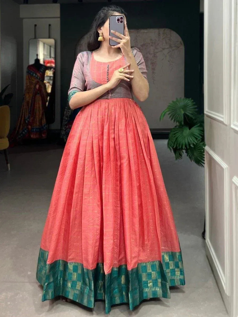 Coral pink ethnic gown with green checkered border, perfect for Indian occasions and festive wear.