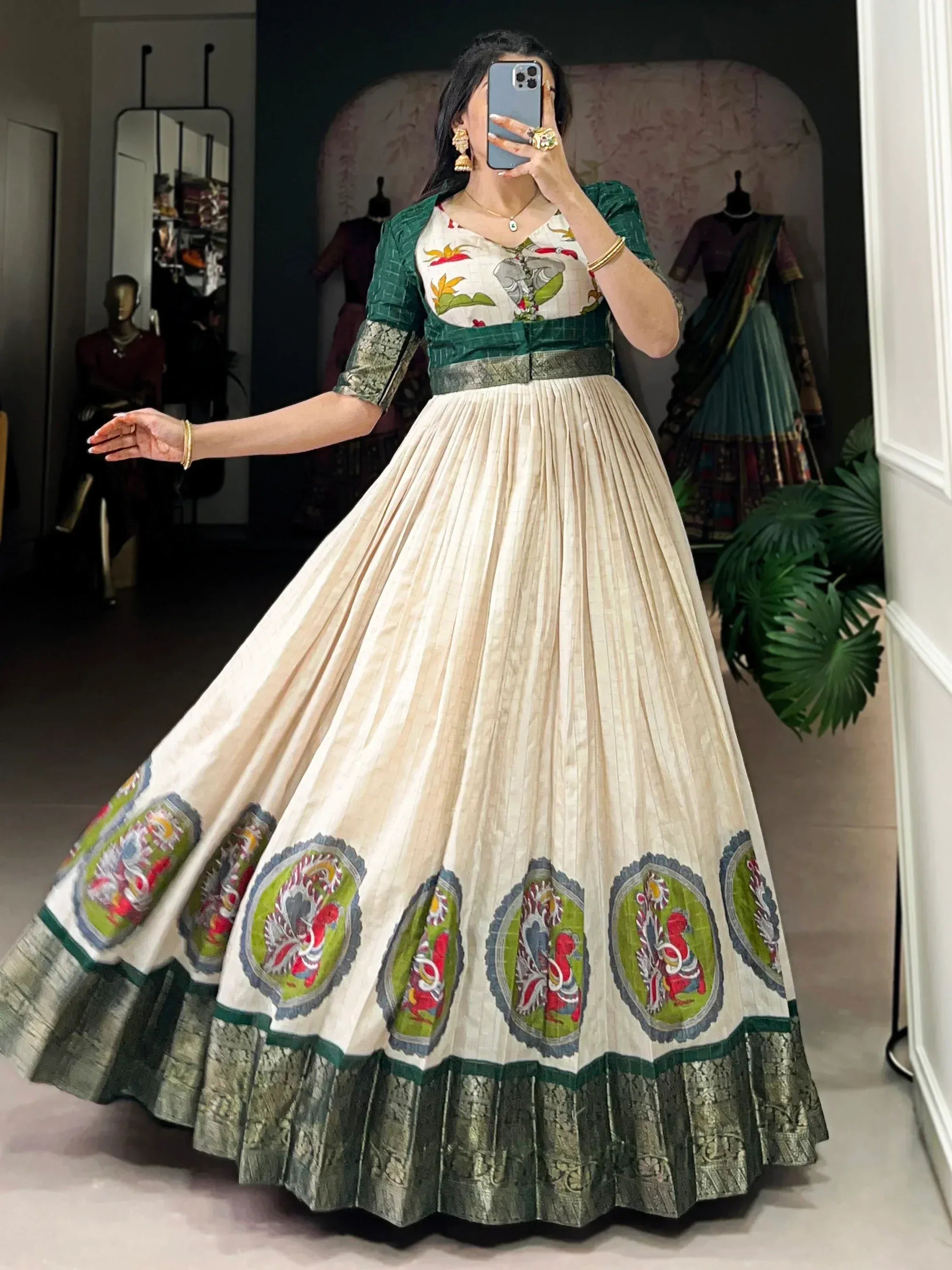 Woman wearing green and cream embroidered lehenga gown with floral and animal motifs