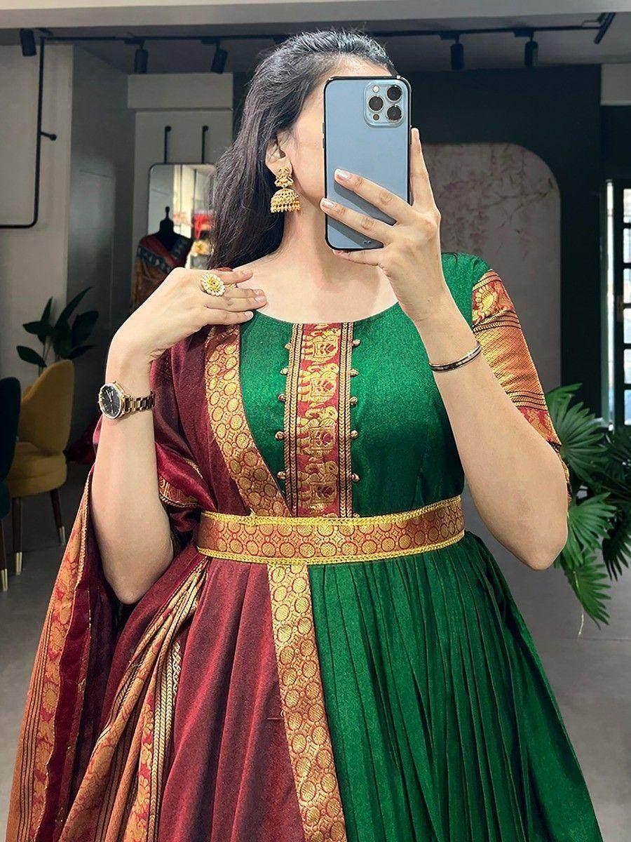 Green and maroon ethnic gown with gold embroidery, perfect for festive occasions and Indian celebrations