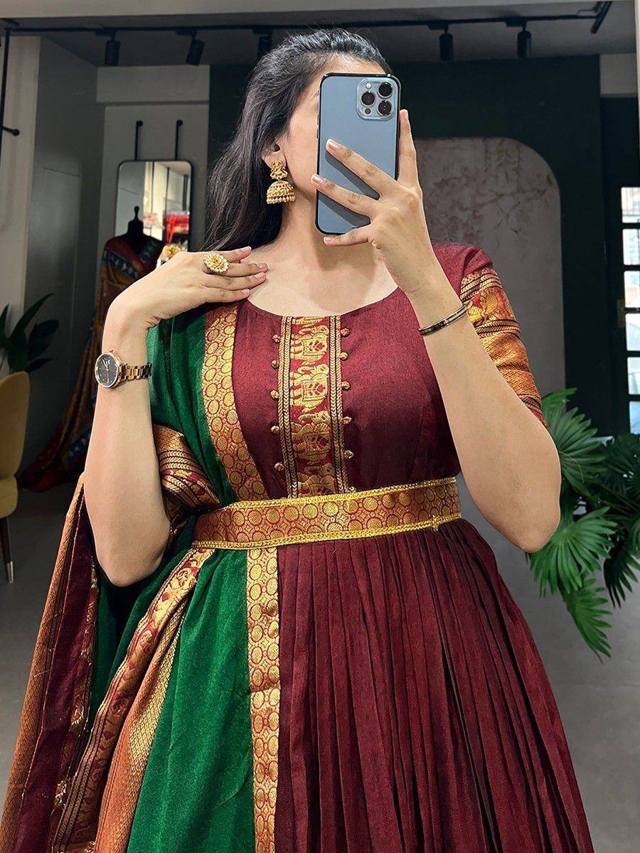 Maroon and green ethnic gown with gold embroidery, perfect for Indian occasions and festive wear.