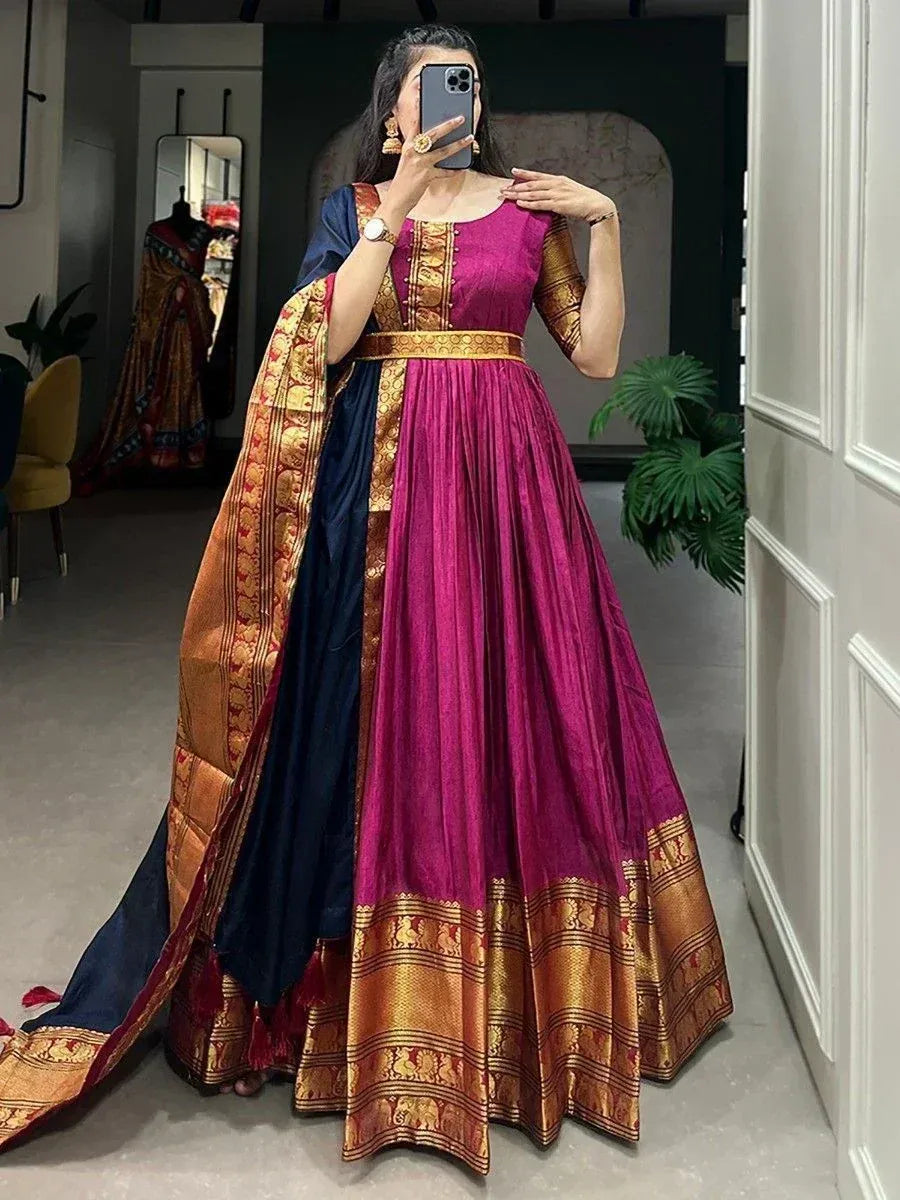 Woman in magenta and navy ethnic gown with gold border, perfect for Indian occasions