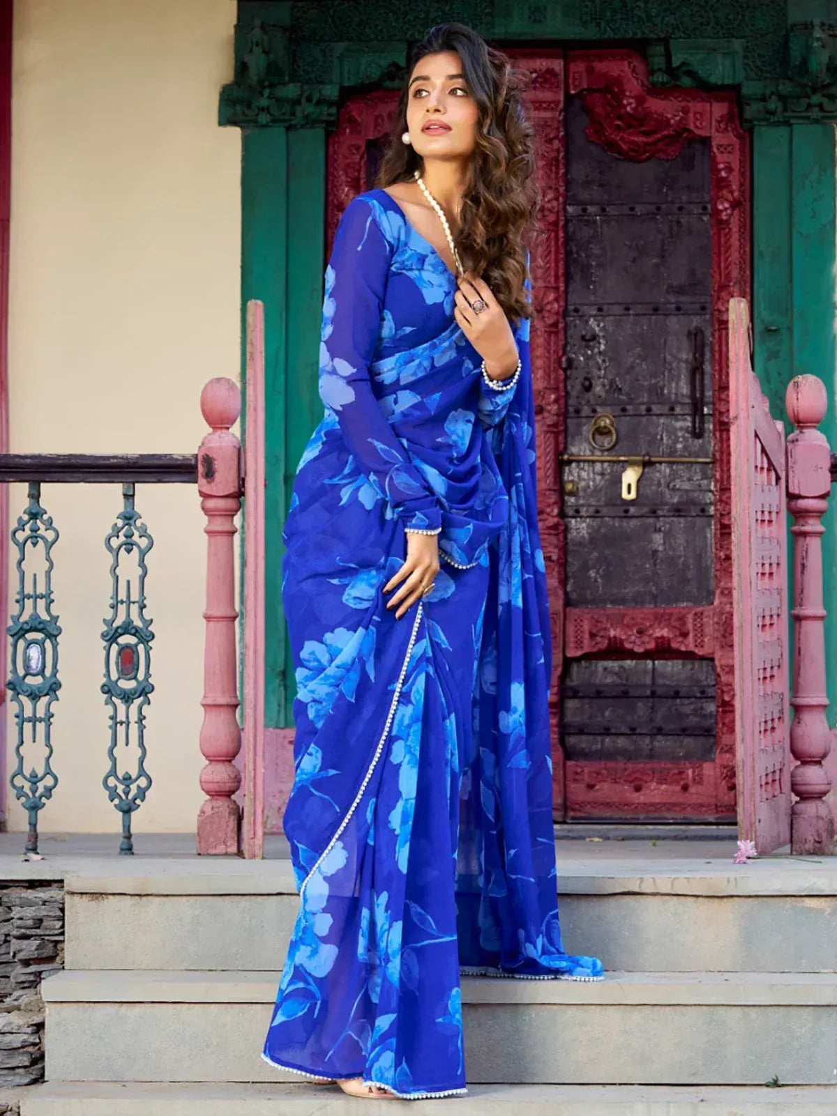 Blue floral saree with pearl border, styled for ethnic wear occasions