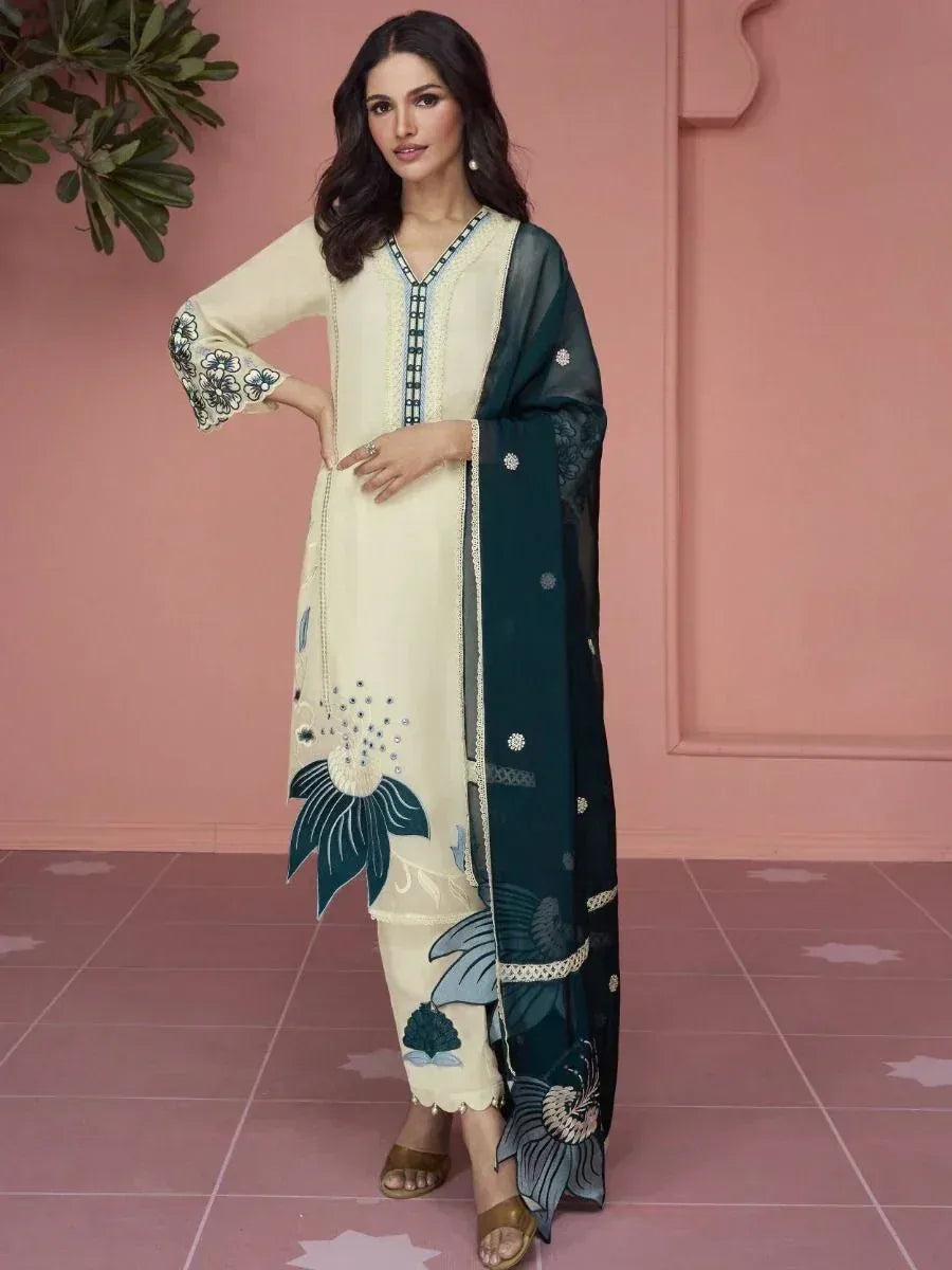 Woman wearing cream and green embroidered salwar kameez with floral patterns, ethnic wear