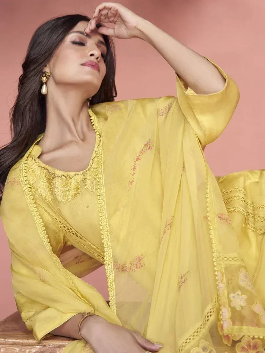 Yellow embroidered salwar kameez with lace detailing, perfect for ethnic occasions