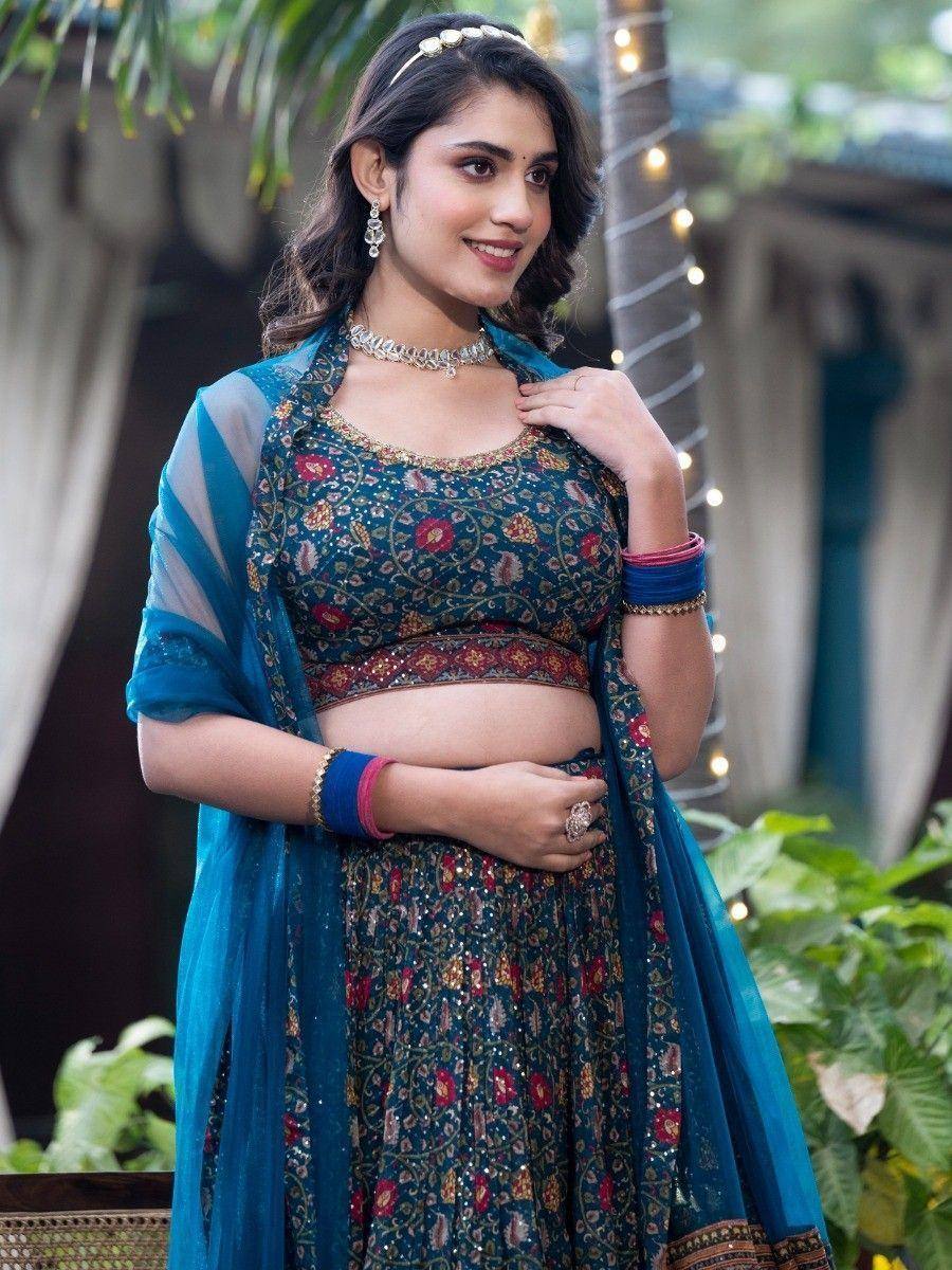 Woman in teal floral lehenga choli with sheer dupatta, perfect for Indian ethnic occasions