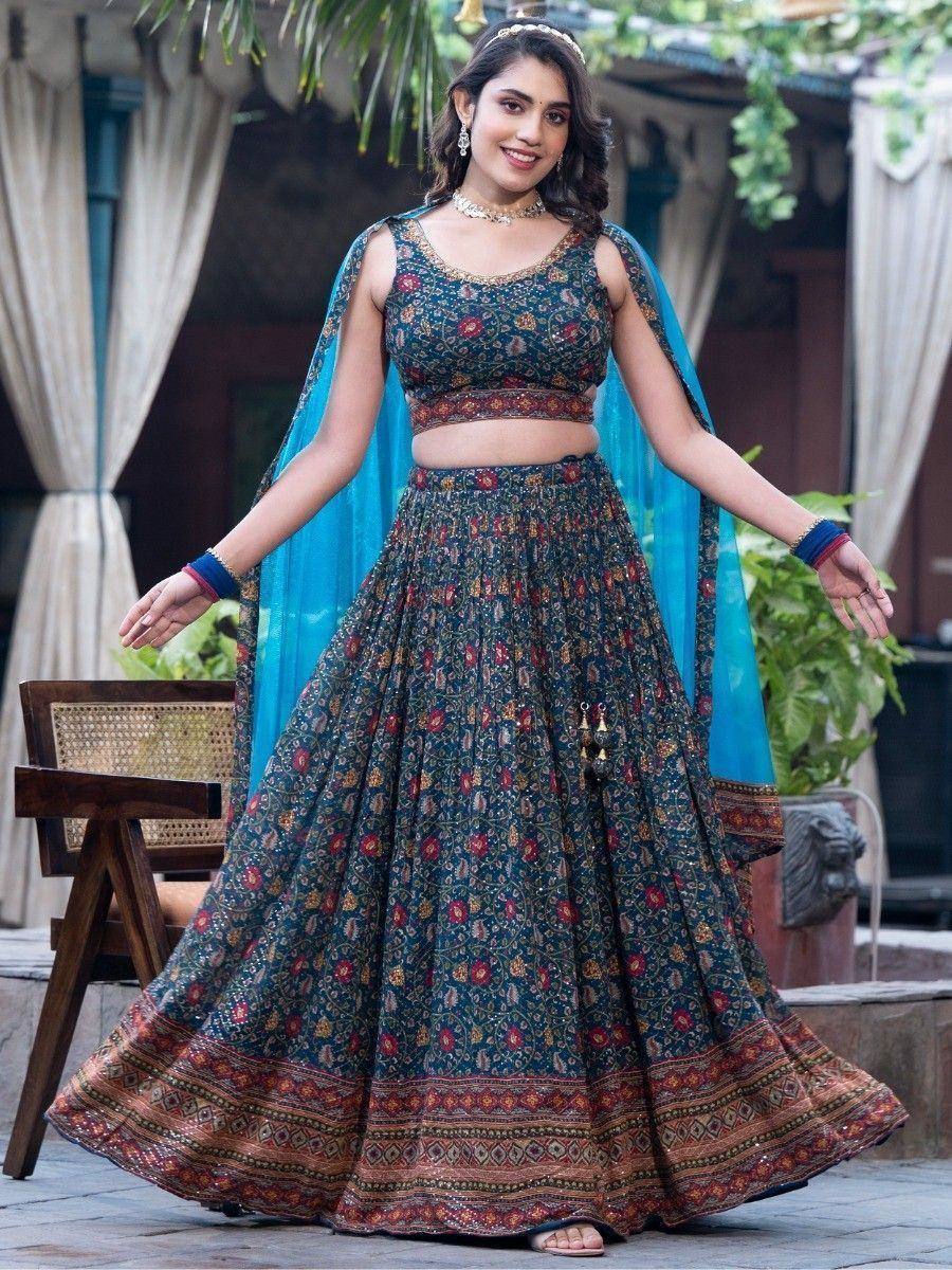 Woman in floral printed lehenga choli with blue dupatta, ethnic Indian wear for festive occasions