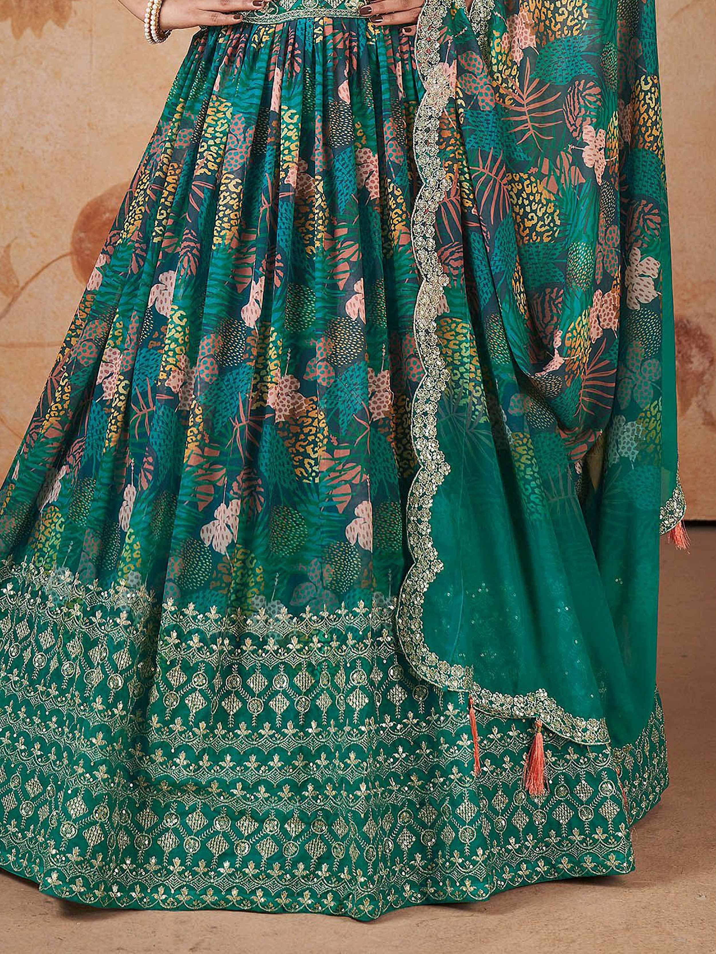 Emerald green lehenga choli with floral print and gold embroidery, perfect for Indian ethnic wear occasions.