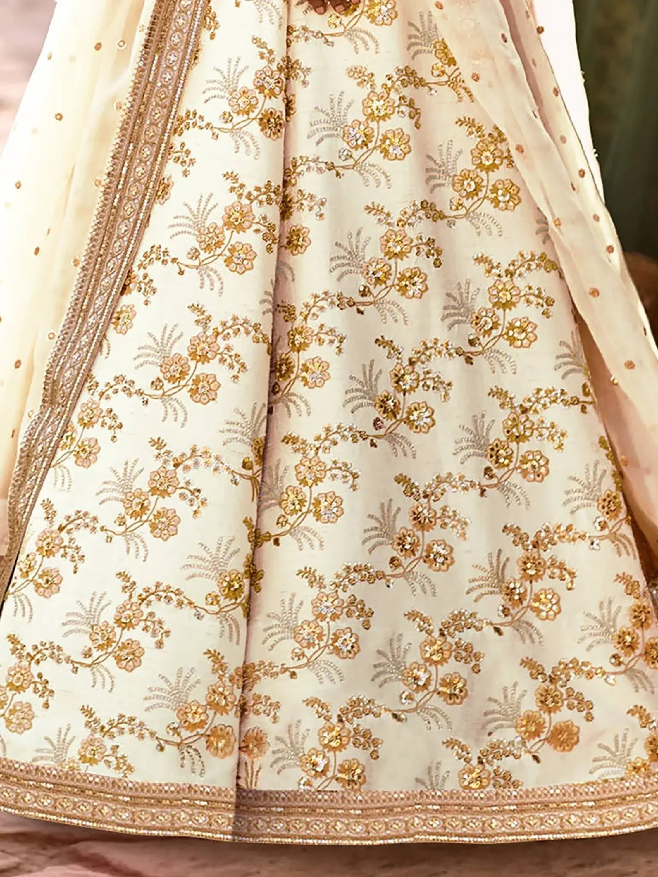 Cream lehenga with gold floral embroidery and sequin detailing, perfect for Indian ethnic wear occasions.