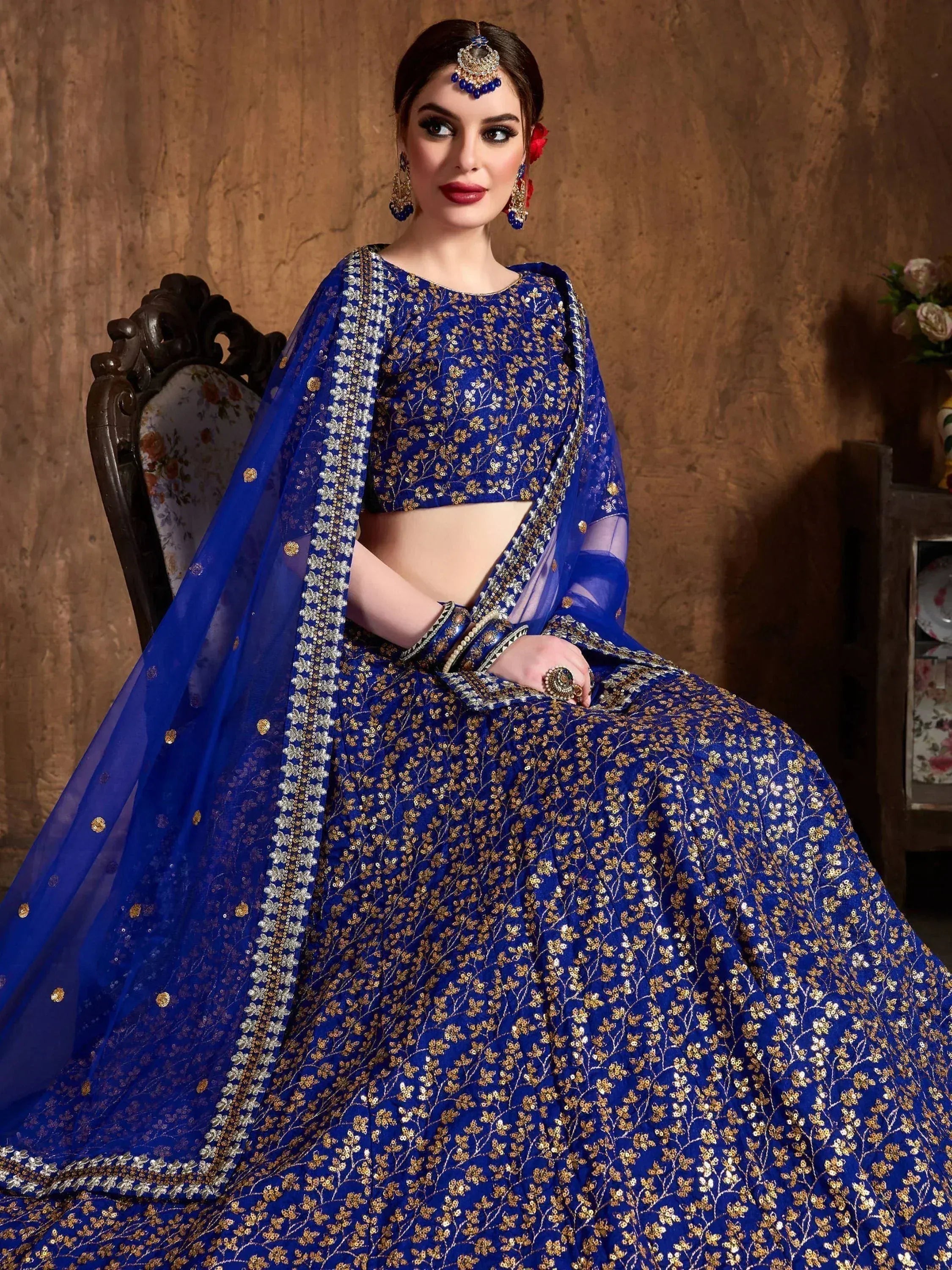 Royal blue designer lehenga choli with gold floral embroidery and matching dupatta, perfect for weddings and festivals