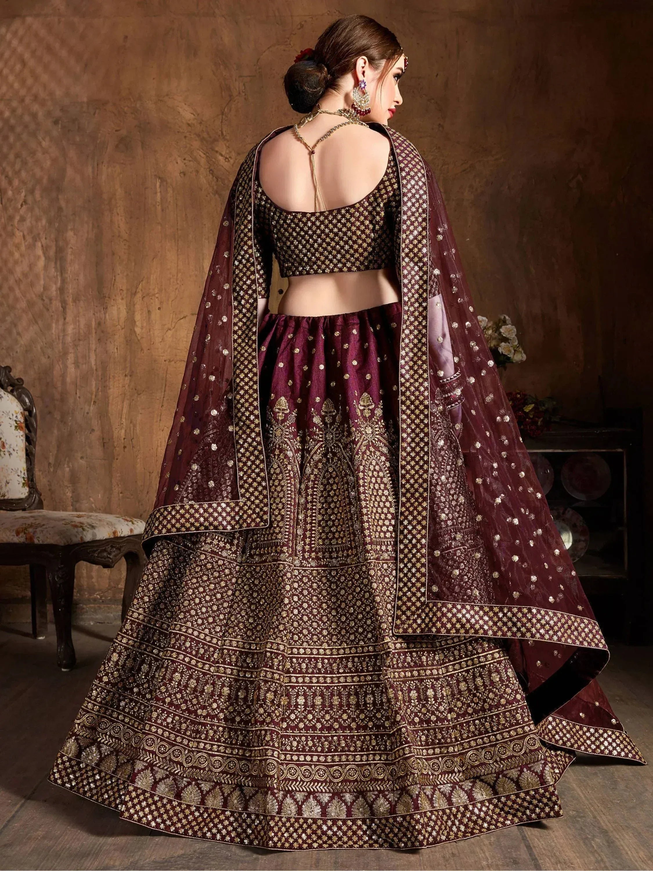 Maroon designer lehenga choli with gold embroidery, back view, ethnic wear for weddings