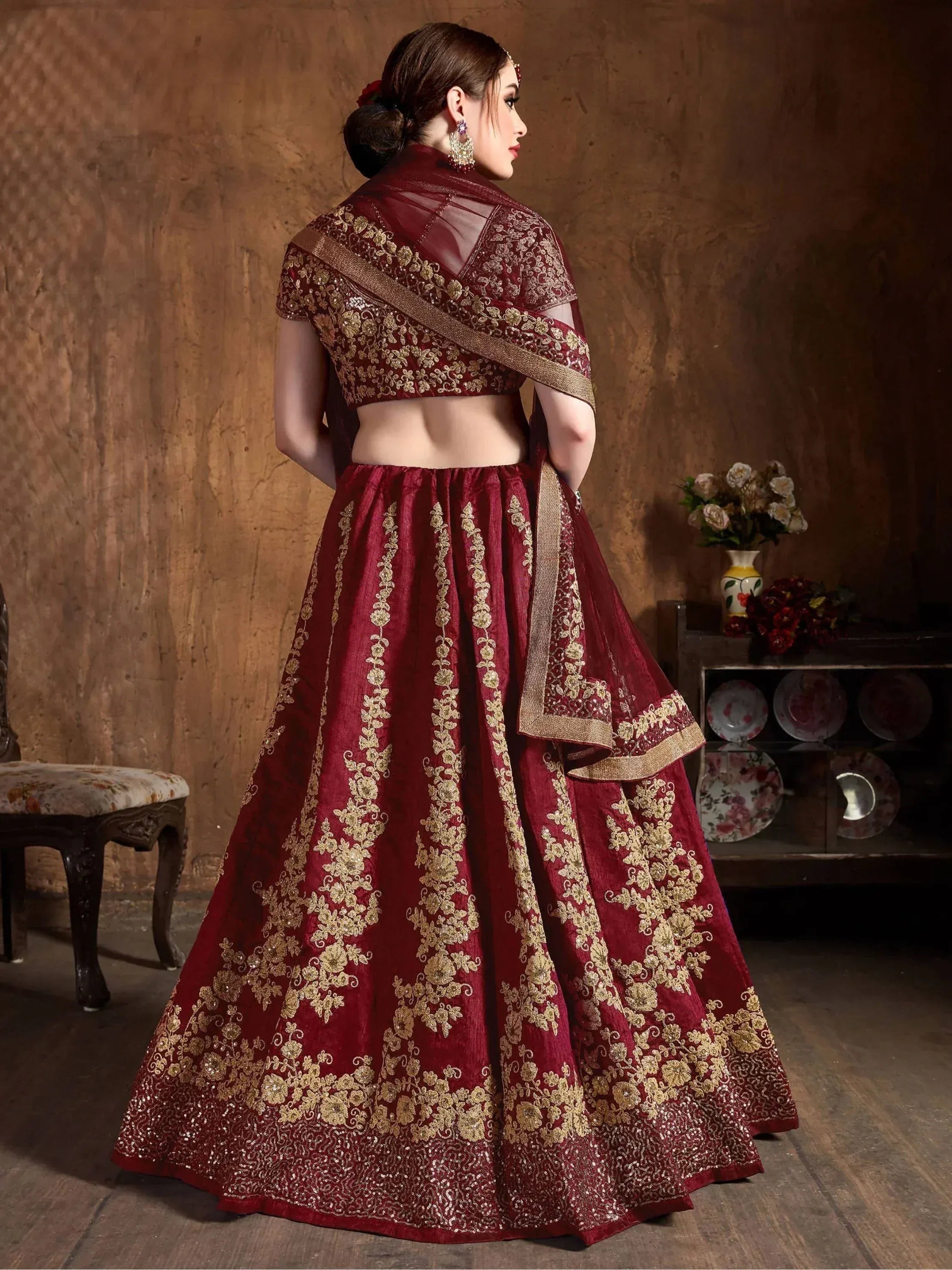 Maroon designer lehenga choli with gold embroidery, perfect for Indian weddings and festive occasions