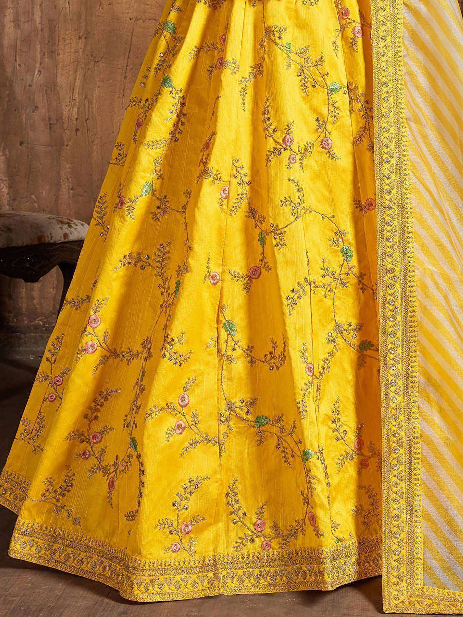 Yellow embroidered lehenga with floral motifs and striped dupatta, ideal for Indian ethnic wear occasions.