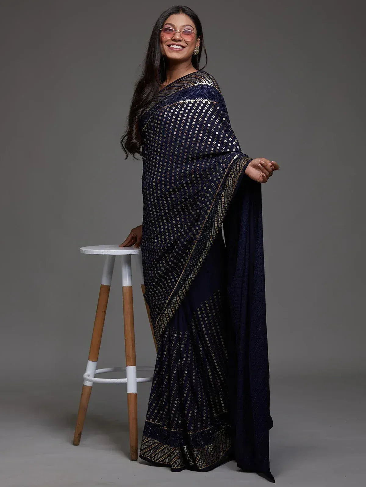 Elegant navy blue saree with golden embellishments, perfect for ethnic occasions