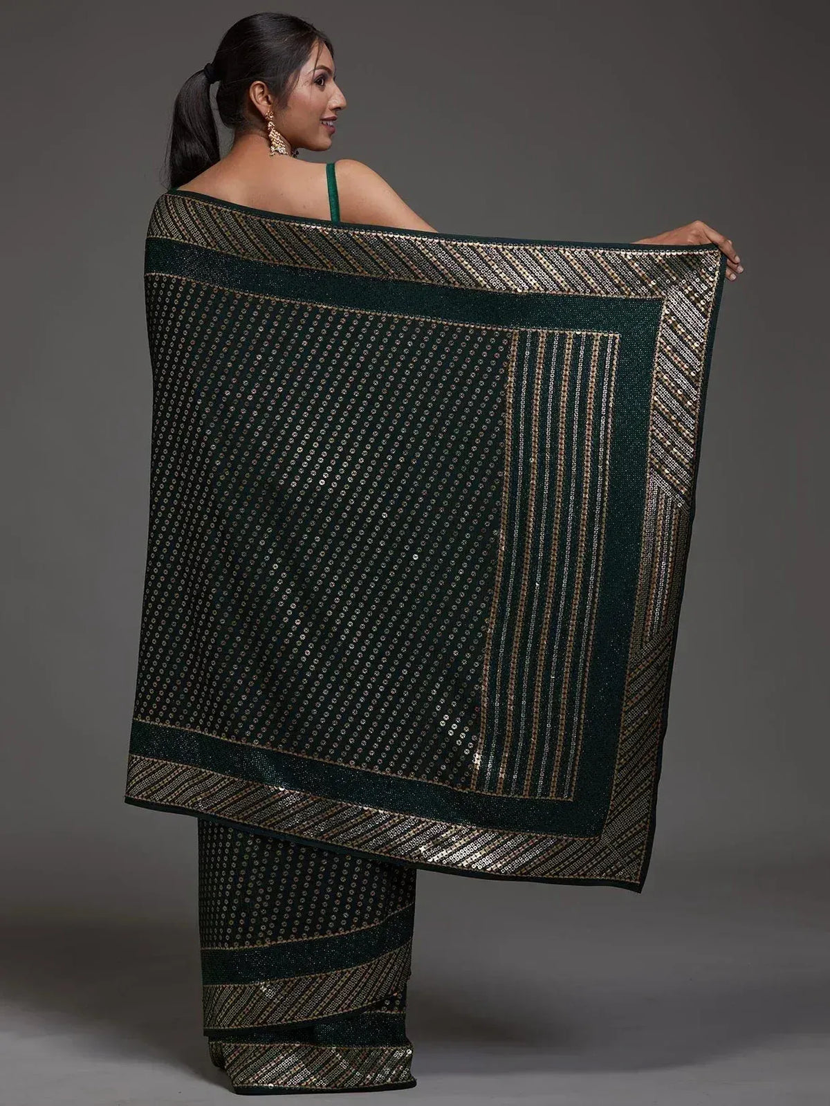 Elegant green saree with golden sequin patterns and border, perfect for ethnic occasions.