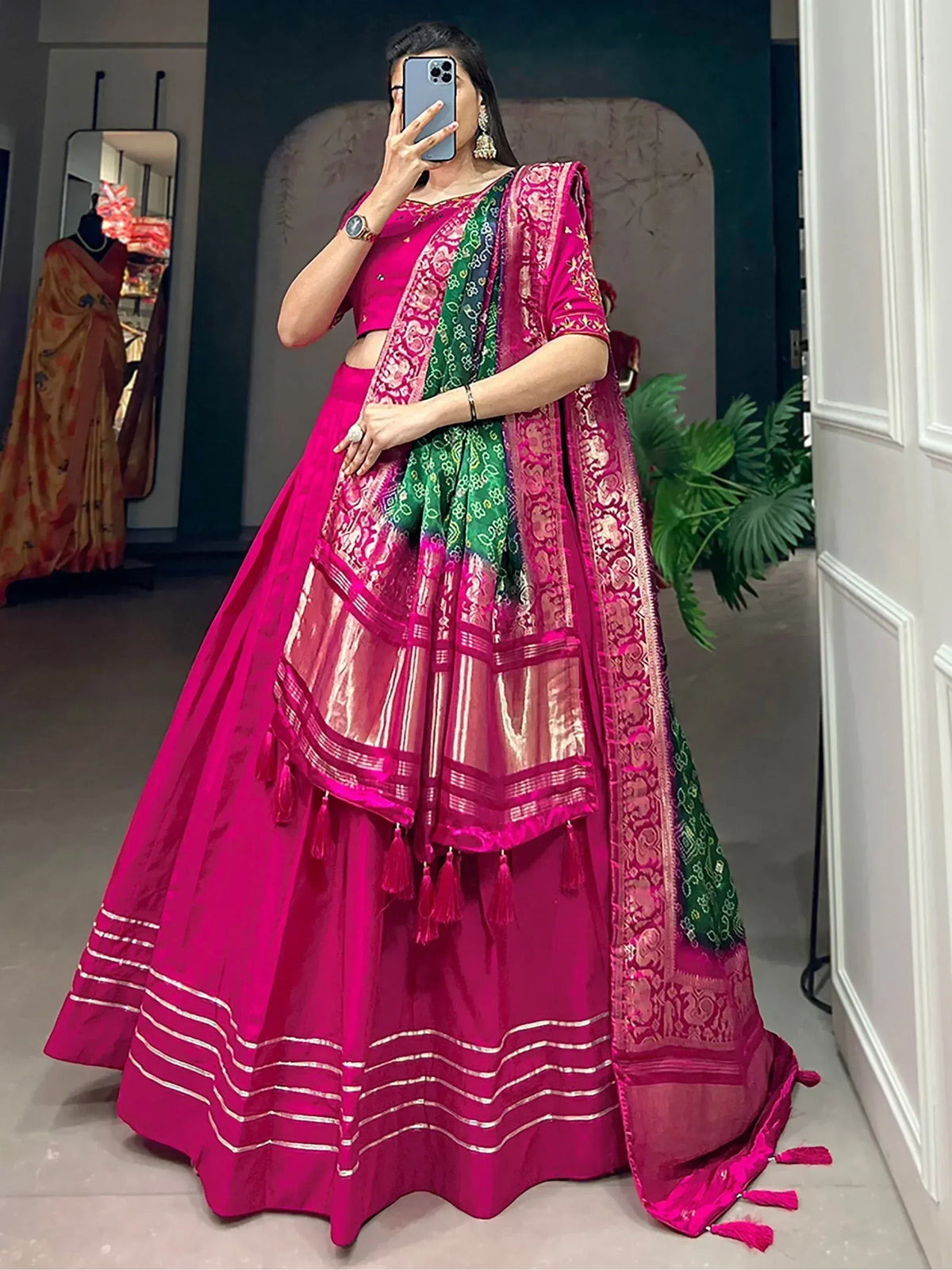 Vibrant pink lehenga choli with green dupatta, perfect for Indian ethnic wear and festive occasions.