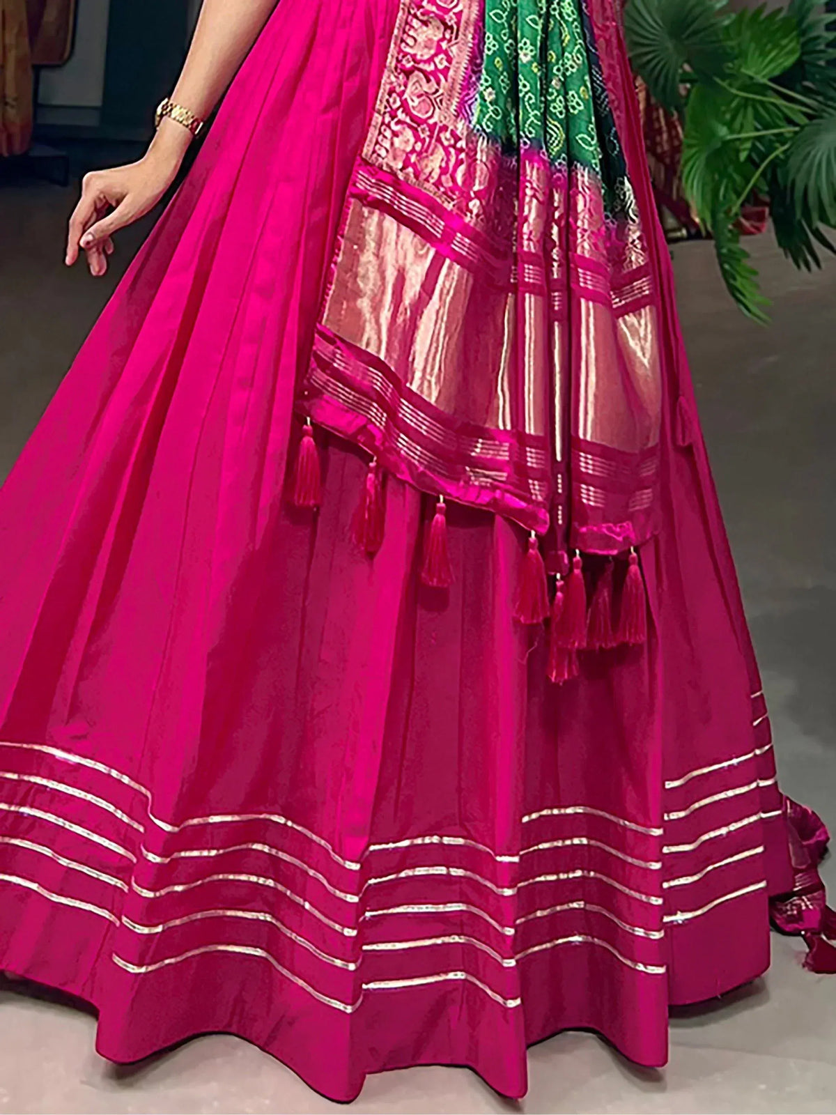 Fuchsia lehenga choli with gold trim and green dupatta, ethnic Indian wear for women