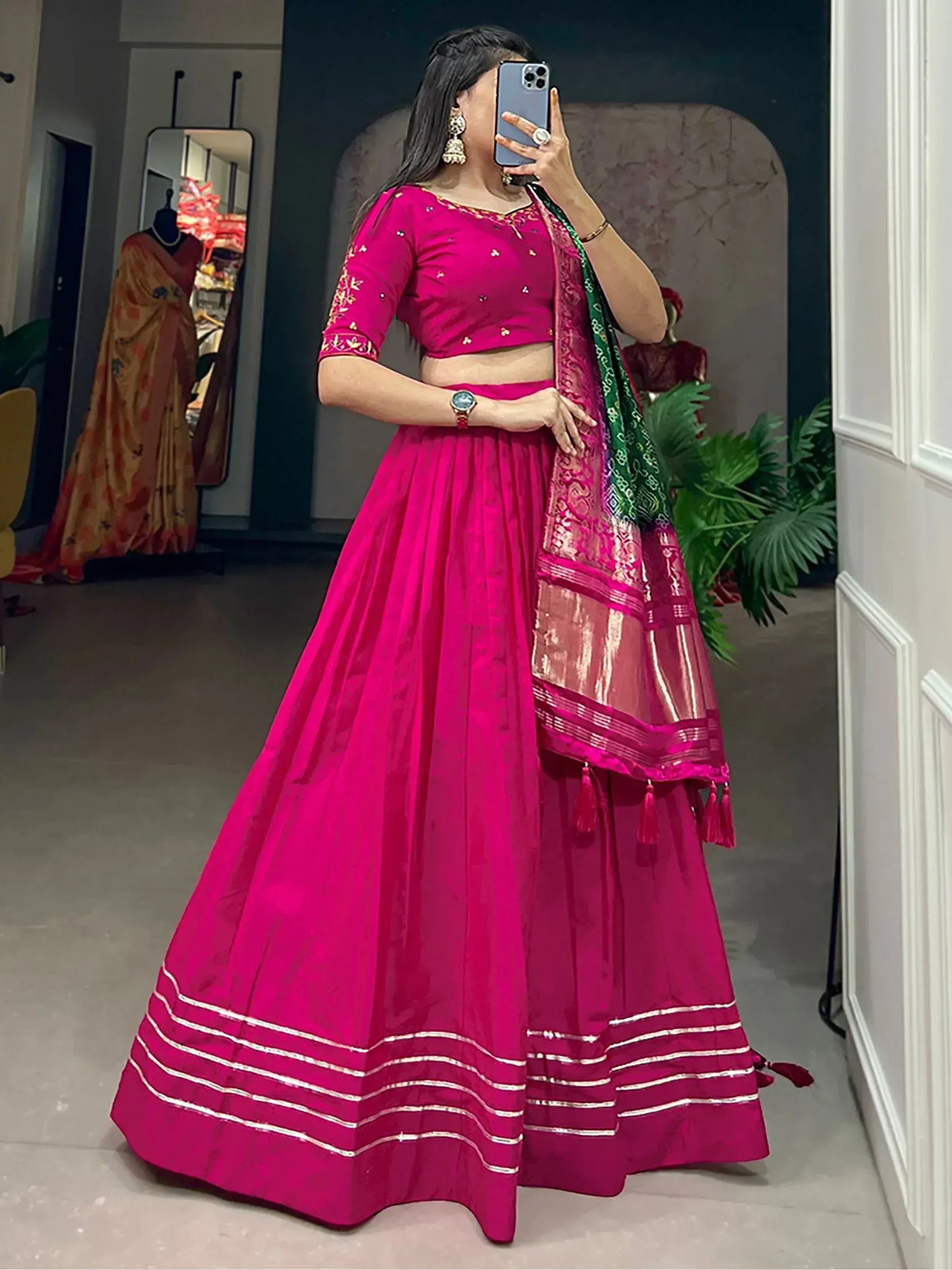 Fuchsia pink lehenga choli with embroidered blouse and contrasting dupatta, perfect for Indian ethnic wear occasions.
