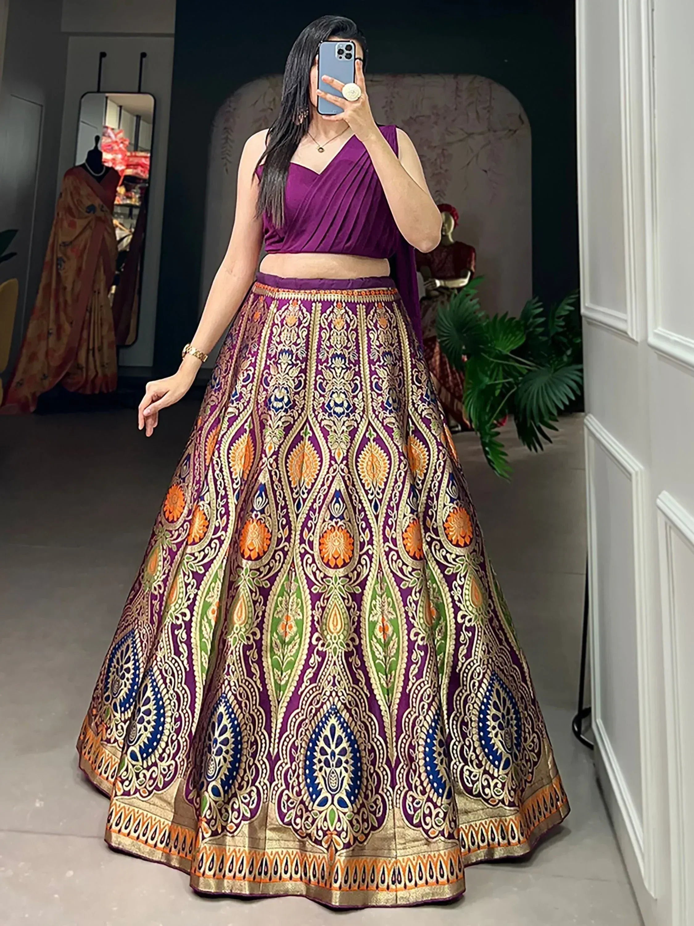 Purple designer lehenga choli with intricate gold and multicolor embroidery, perfect for Indian ethnic wear.