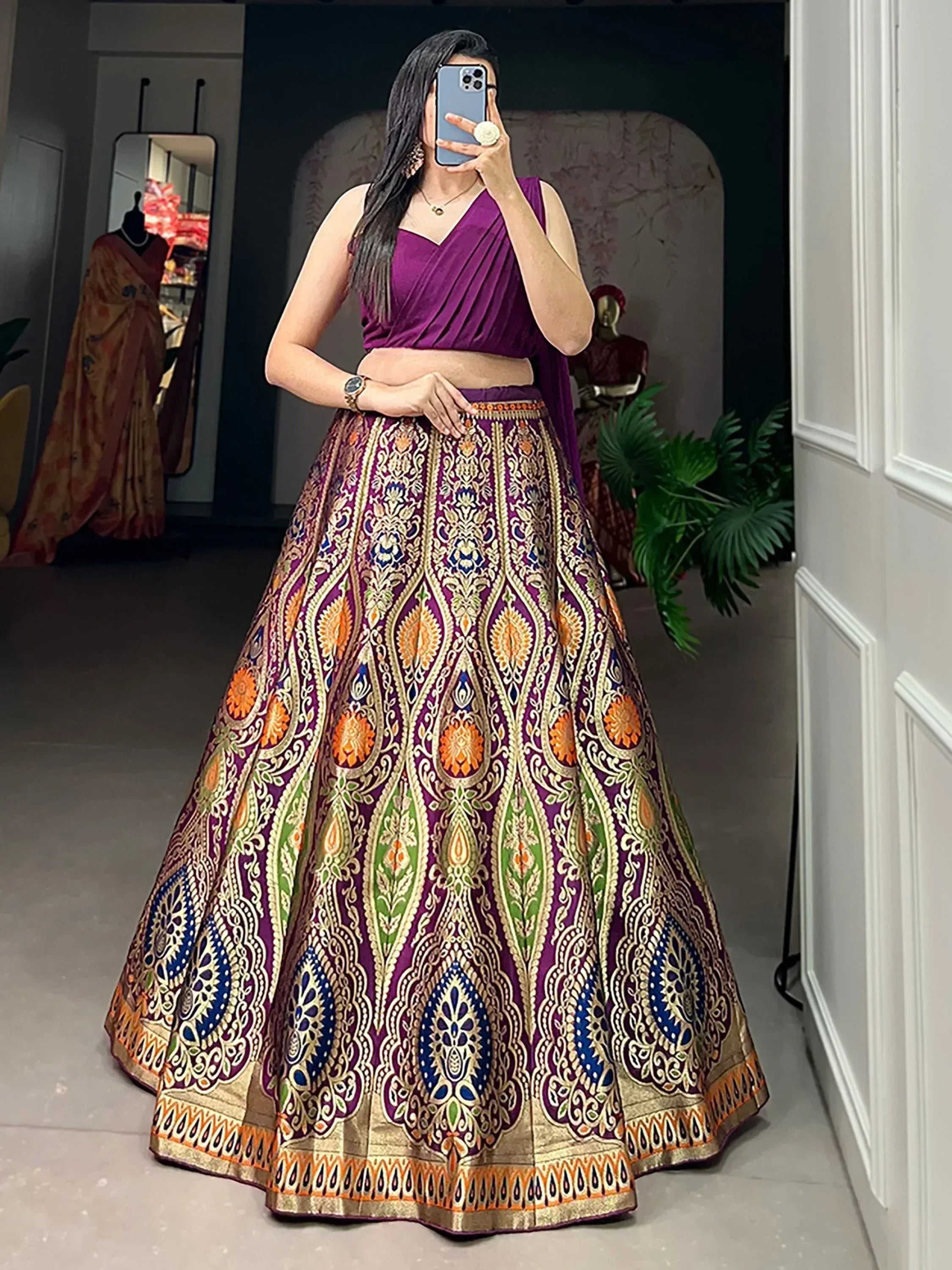 Purple designer lehenga choli with intricate gold and multicolor embroidery, perfect for Indian ethnic wear.